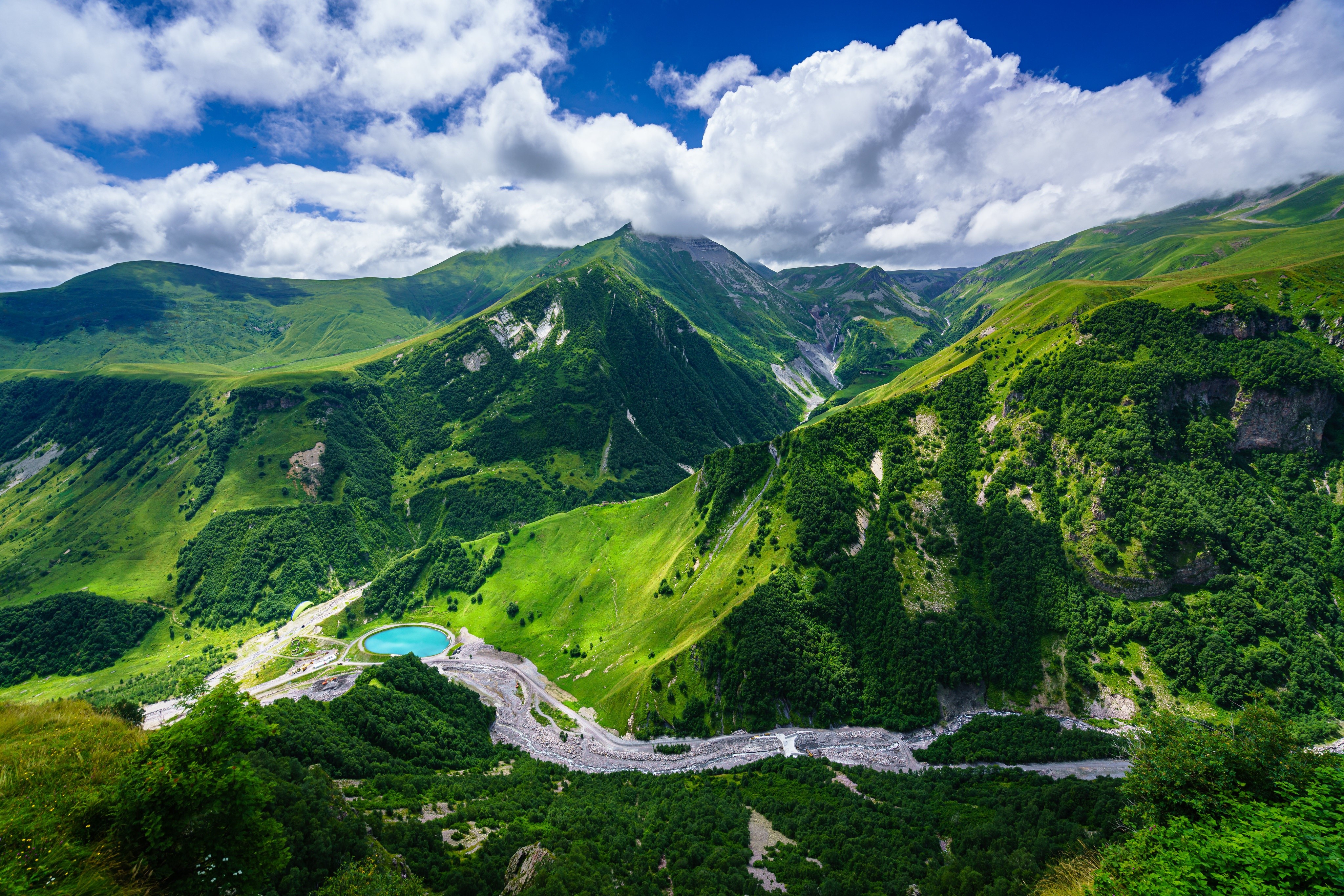 mountains, landscape, clouds, trees, paragliding, construction vehicles, HD Wallpaper