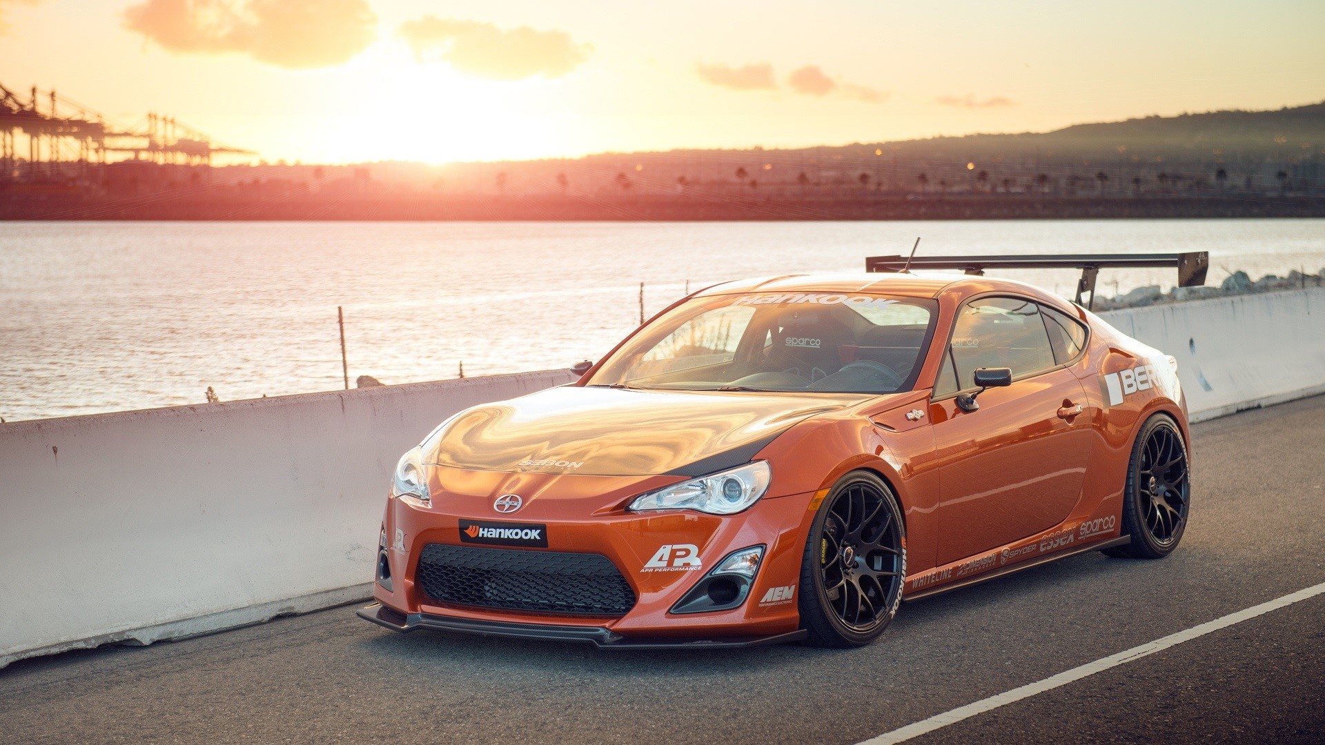 sports car, orange cars, car, vehicle, sunlight, daylight, water, road, sky, clouds, nature, asphalt, Toyobaru, HD Wallpaper