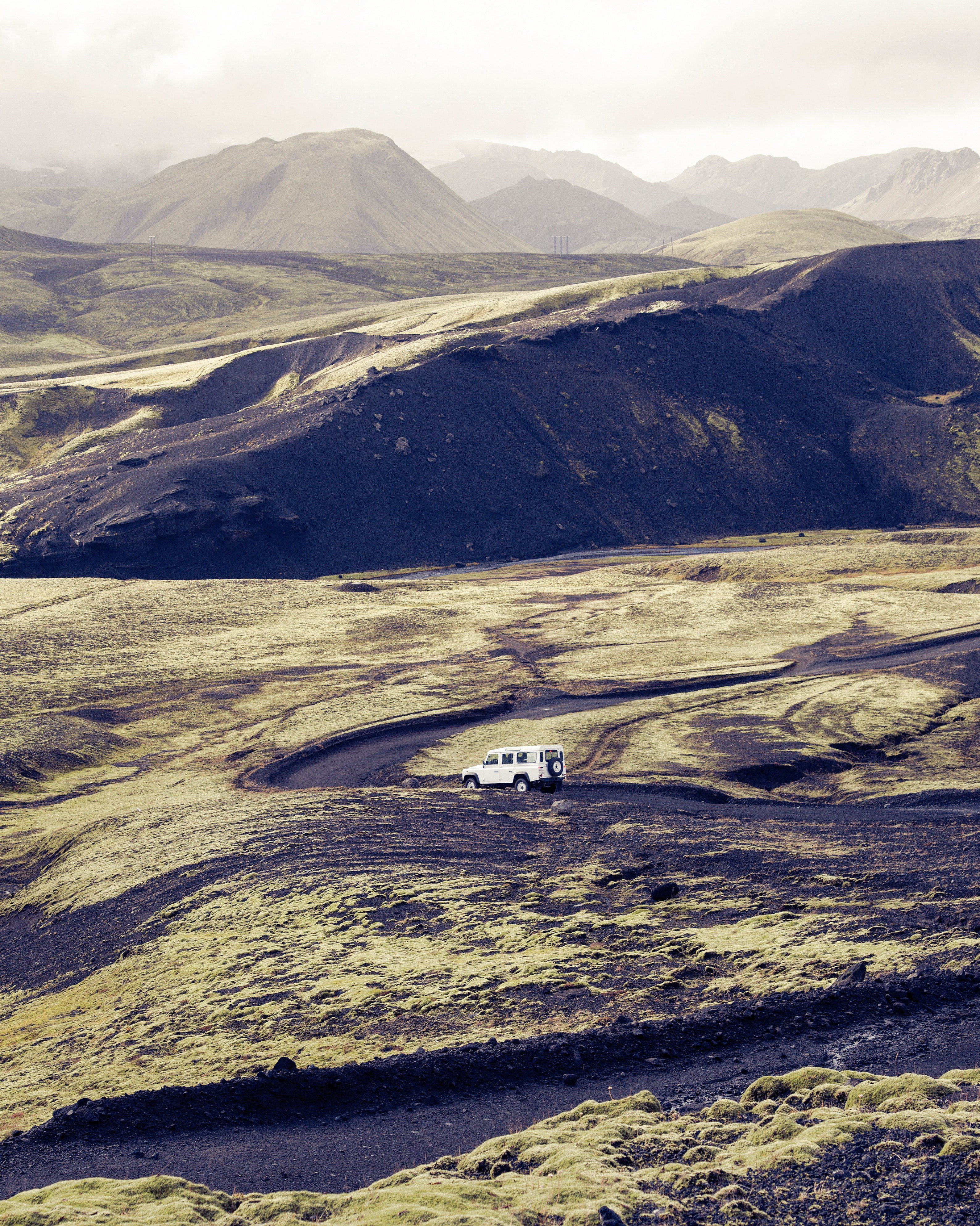 a white suv driving along a zigzagging dirt road among mossy rocks, mossy zigzagging road 4k, Phone HD Wallpaper