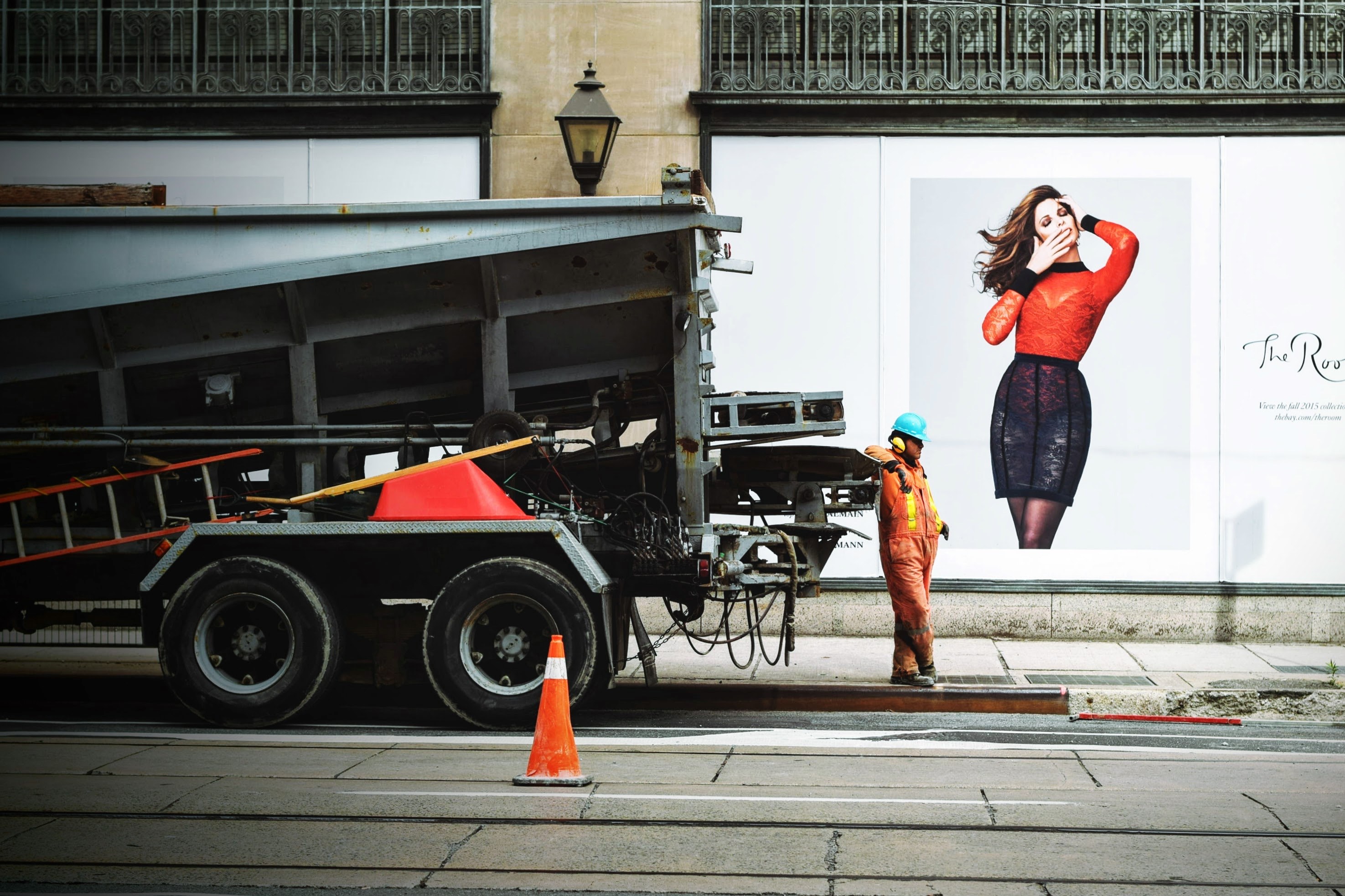 a construction worker stands alongside a truck with a wall of advertisements behind him, construction worker and ad 4k, HD Wallpaper