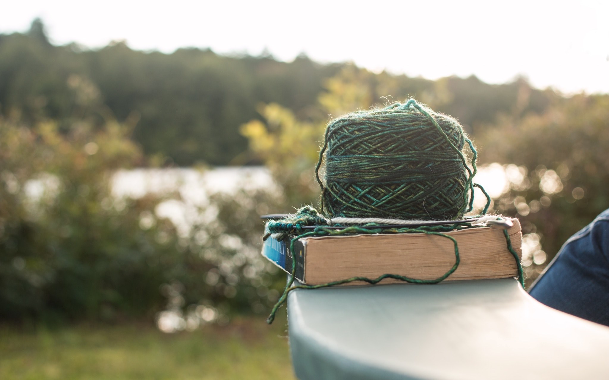 a ball of yarn on a book on a ledge near a lake, crafty hobbies 4k, HD Wallpaper
