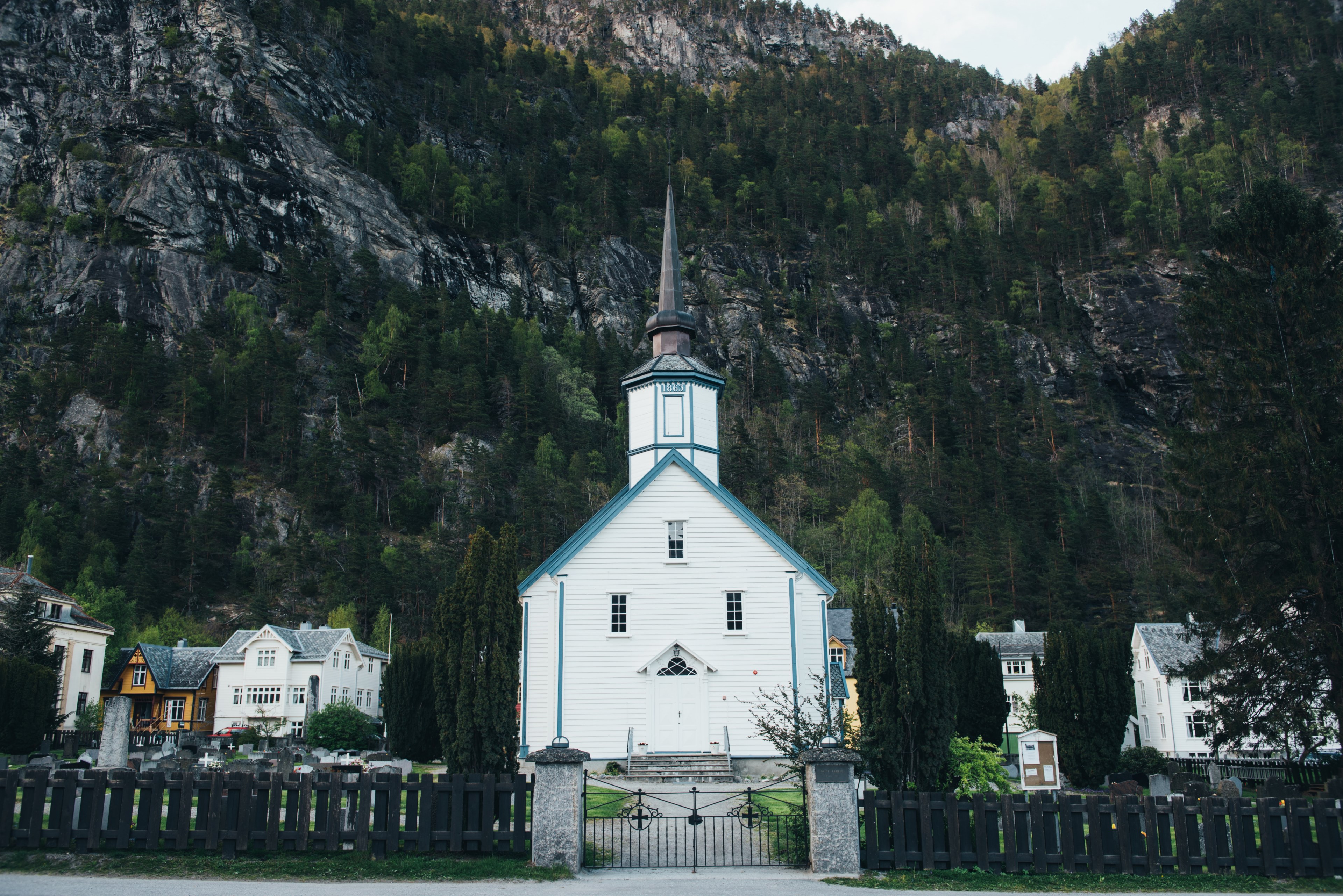 several houses and a small white church at the foot of a tall mountain, church at a mountains foot 4k, HD Wallpaper