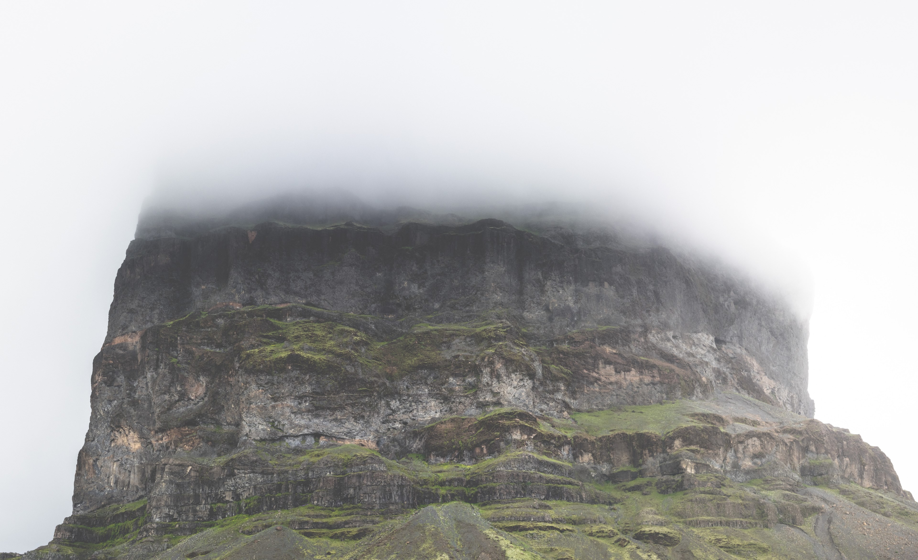 the base of a mossy rock tower with its top shrouded in thick fog, foggy rock tower 4k, HD Wallpaper