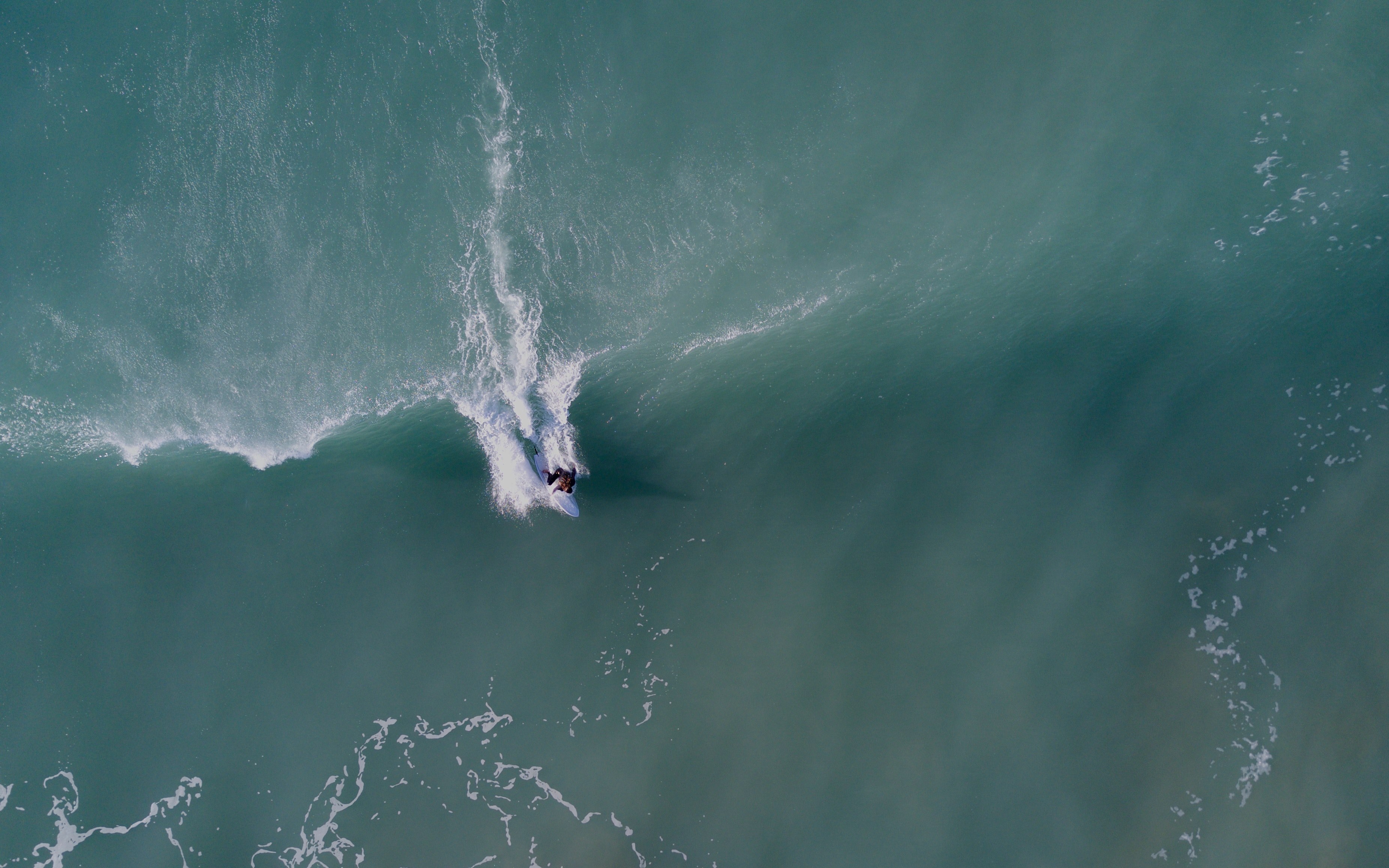 a drone shot of a surfer riding a wave in gisborne new zealand, super woman 4k, HD Wallpaper