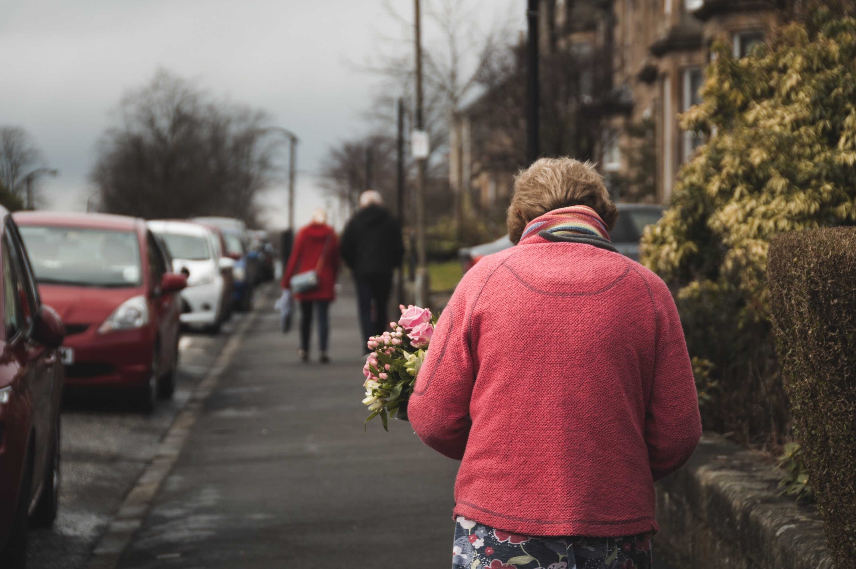 an elderly lady with a bouquet of flowers walking on a suburban sidewalk, lady with a floral bouquet 4k, HD Wallpaper