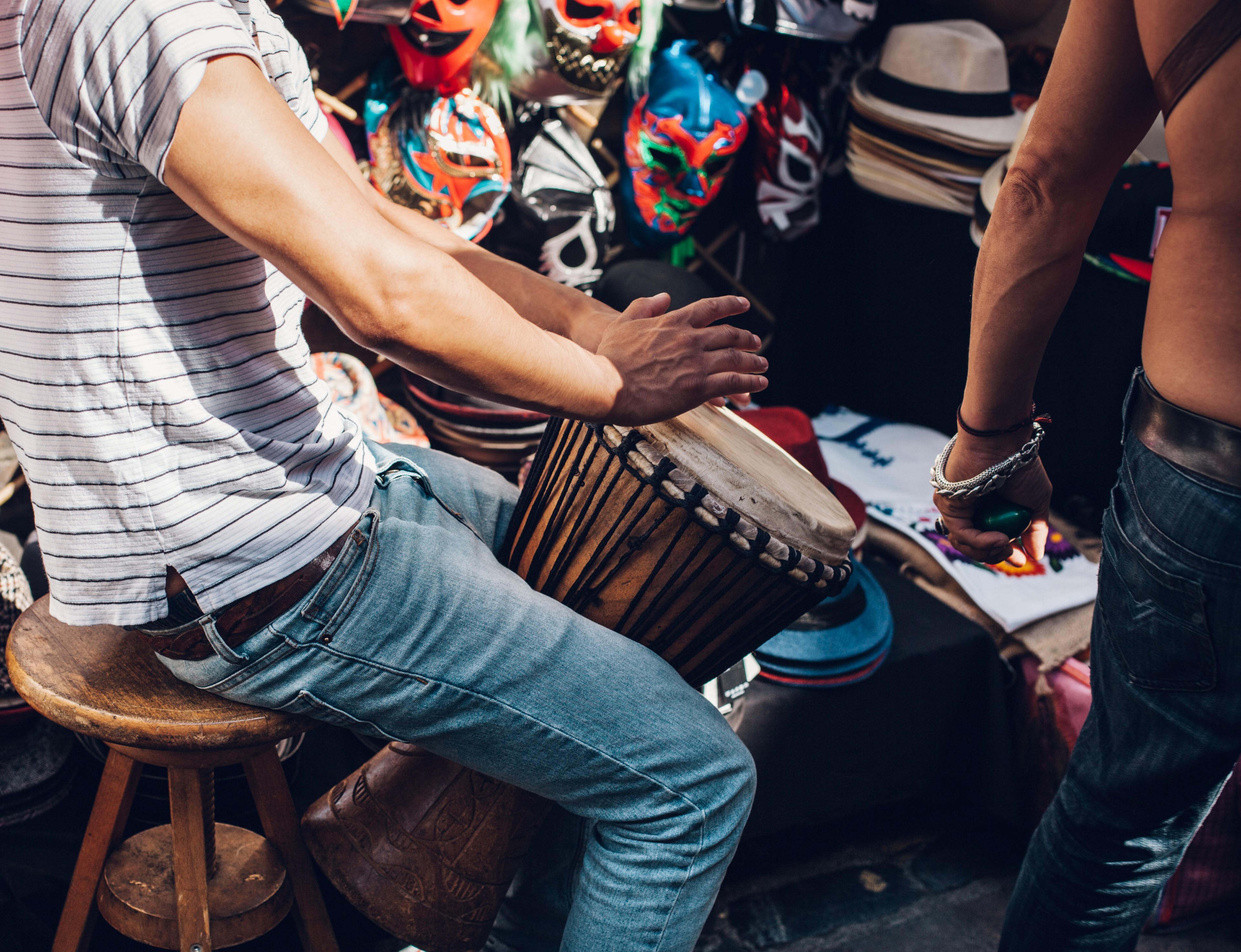 a man in jeans and t shirt playing a tall drum on brick lane market, drummer on brick lane market 4k, HD Wallpaper