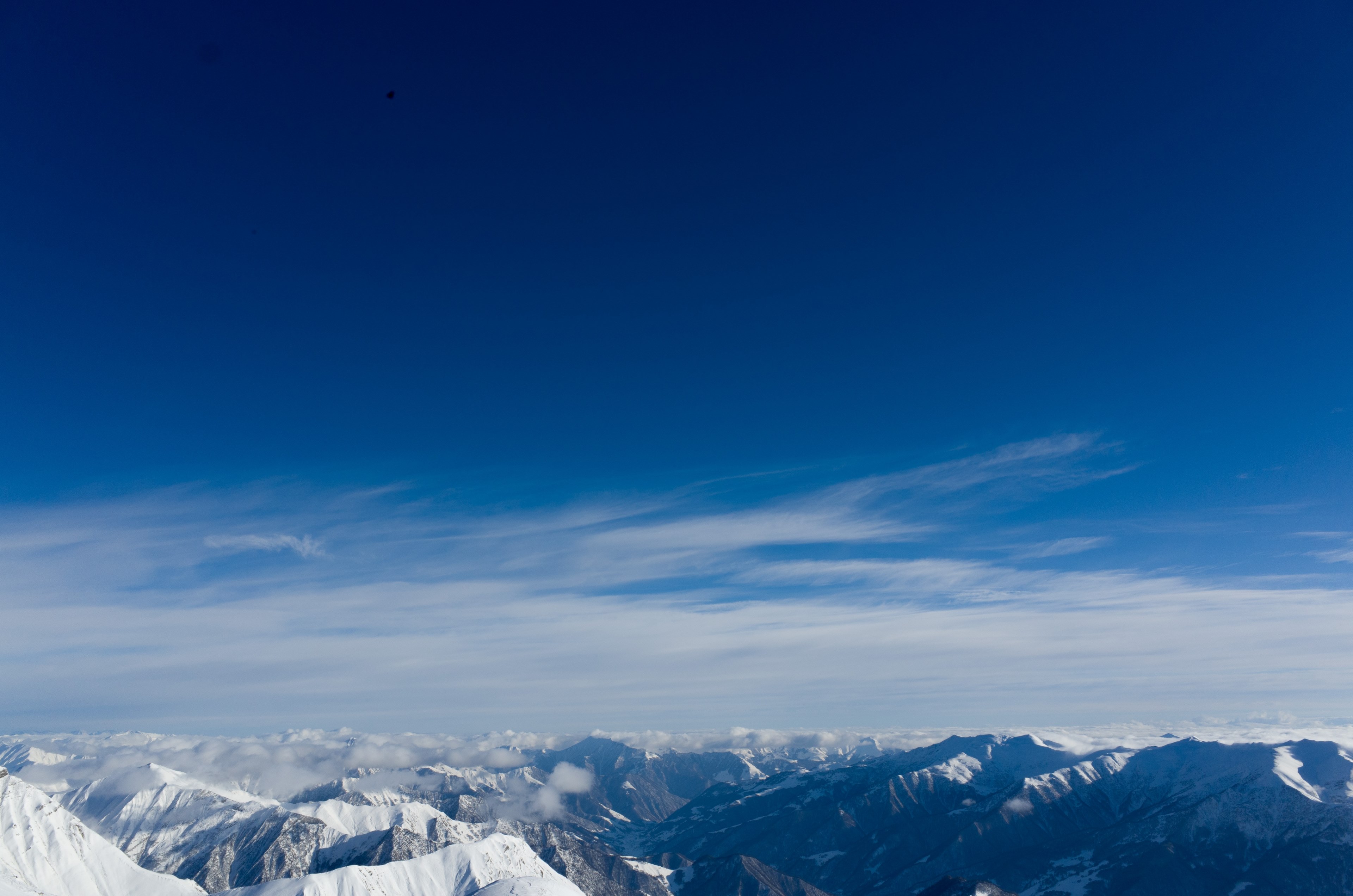 a dramatic mountainous landscape under a blue sky, sea of snowy peaks 4k, HD Wallpaper
