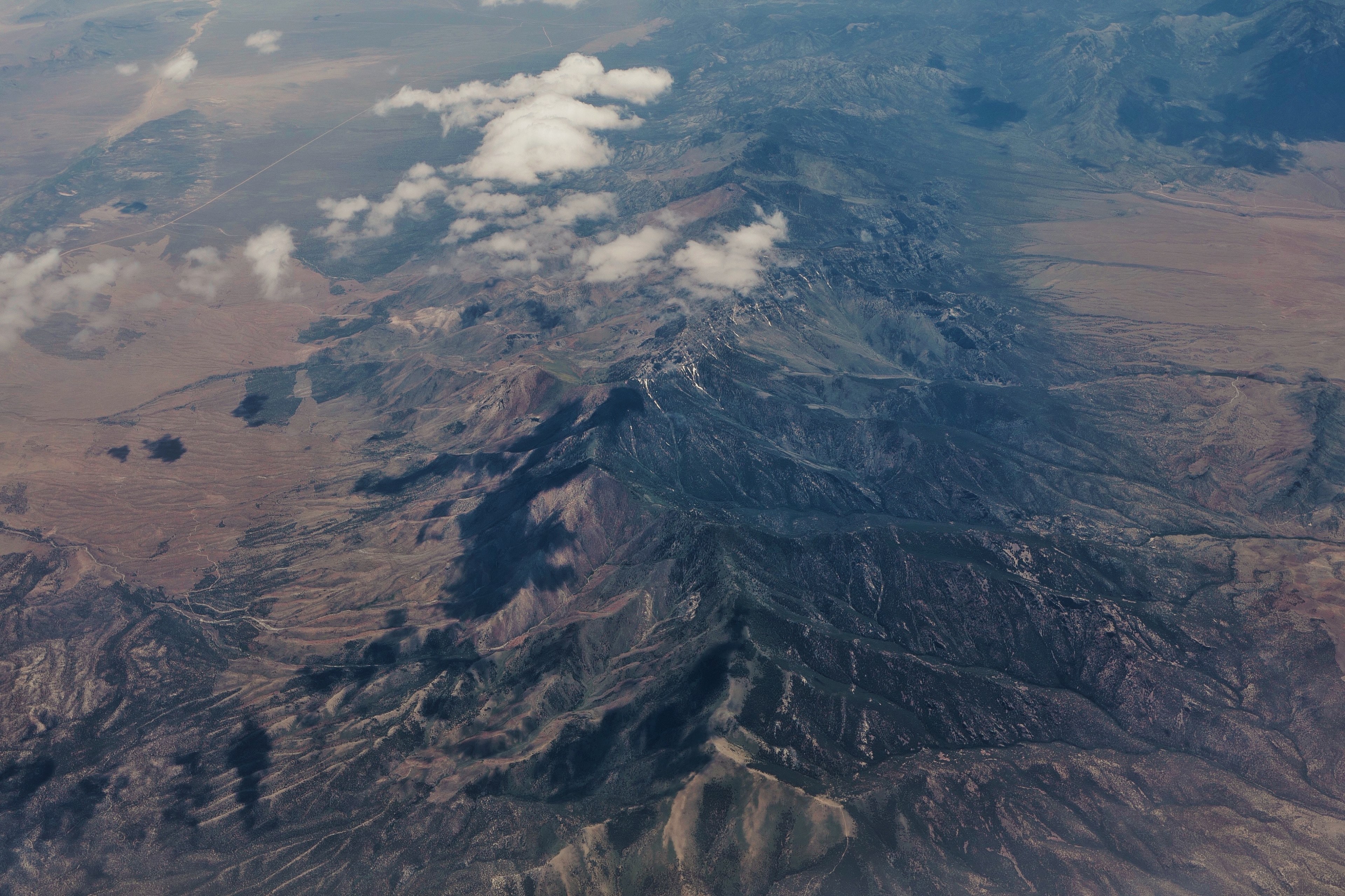 an aerial view of a vast mountain range partly obscured by clouds, birds eye view of the mountains 4k, HD Wallpaper