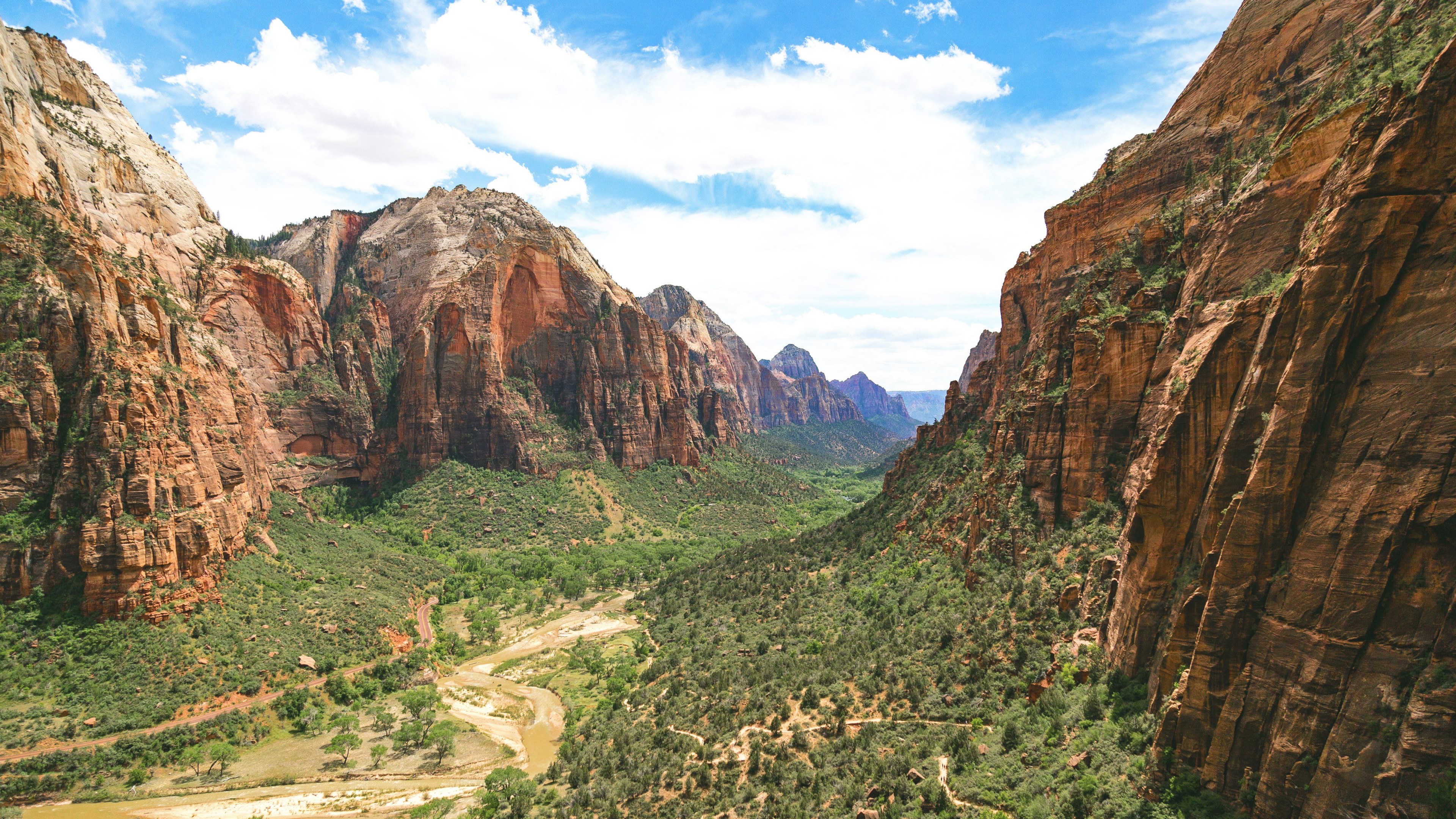 a green valley surrounded by sandstone cliffs in zion national park, valley between red hills 4k, HD Wallpaper