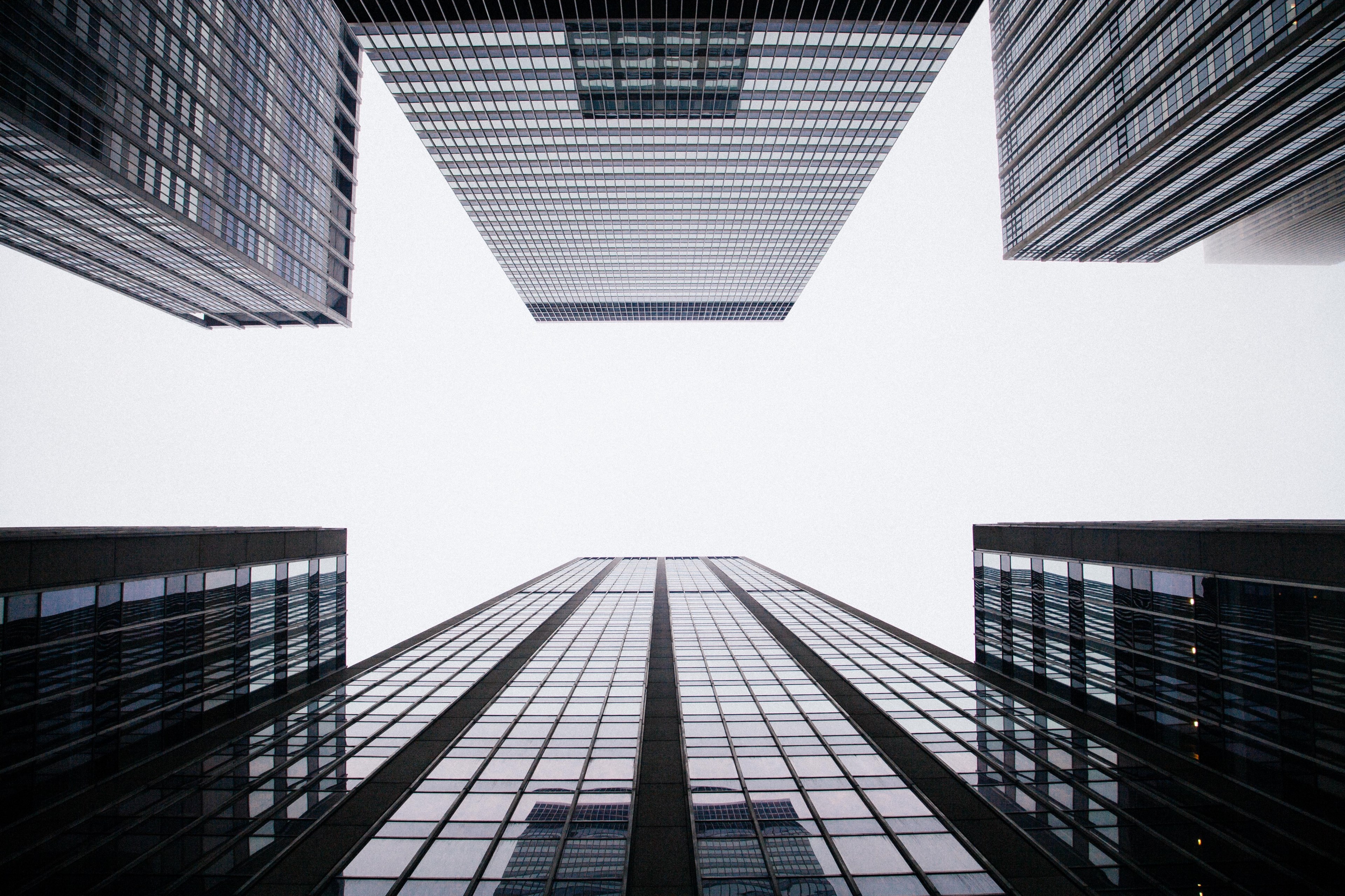 a low angle shot of tall office buildings on a cloudy day, office buildings under clouds 4k, HD Wallpaper