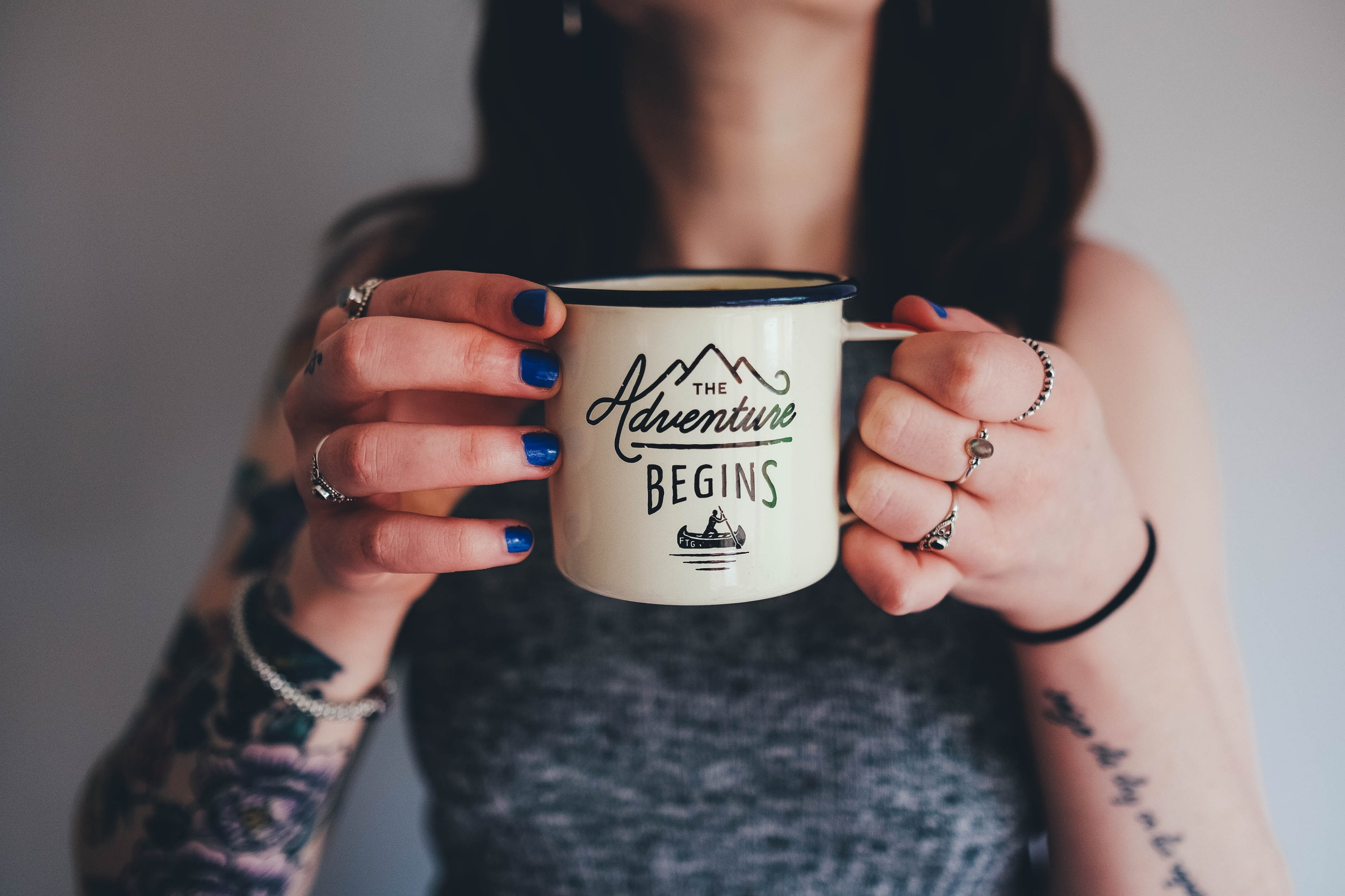 a woman with tattooed arms holding an enamel cup with the adventure begins written on it, the adventure begins cup 4k, HD Wallpaper