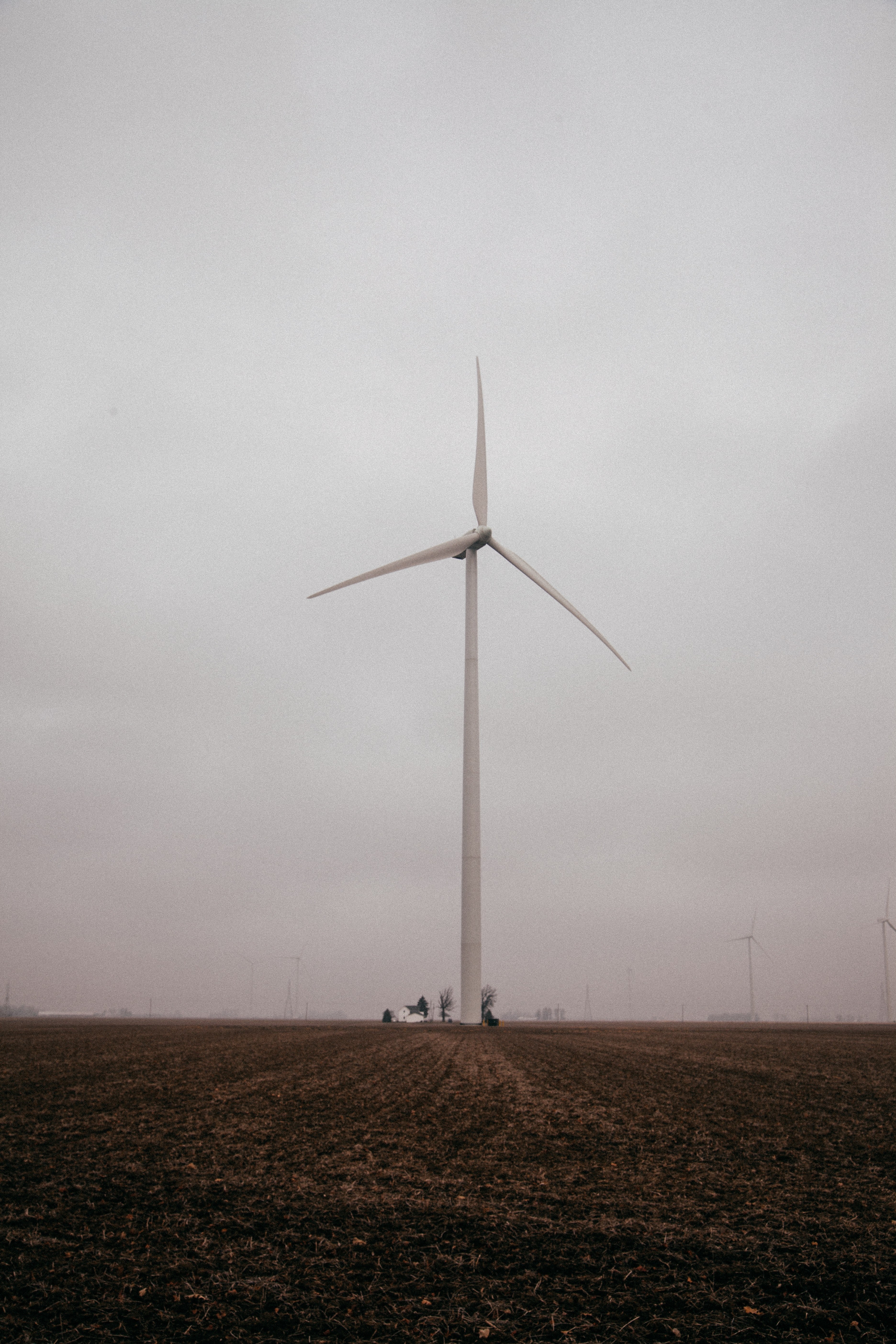 single wind turbine in a farm field on a cloudy day, windmill in a farm field 4k, Phone HD Wallpaper