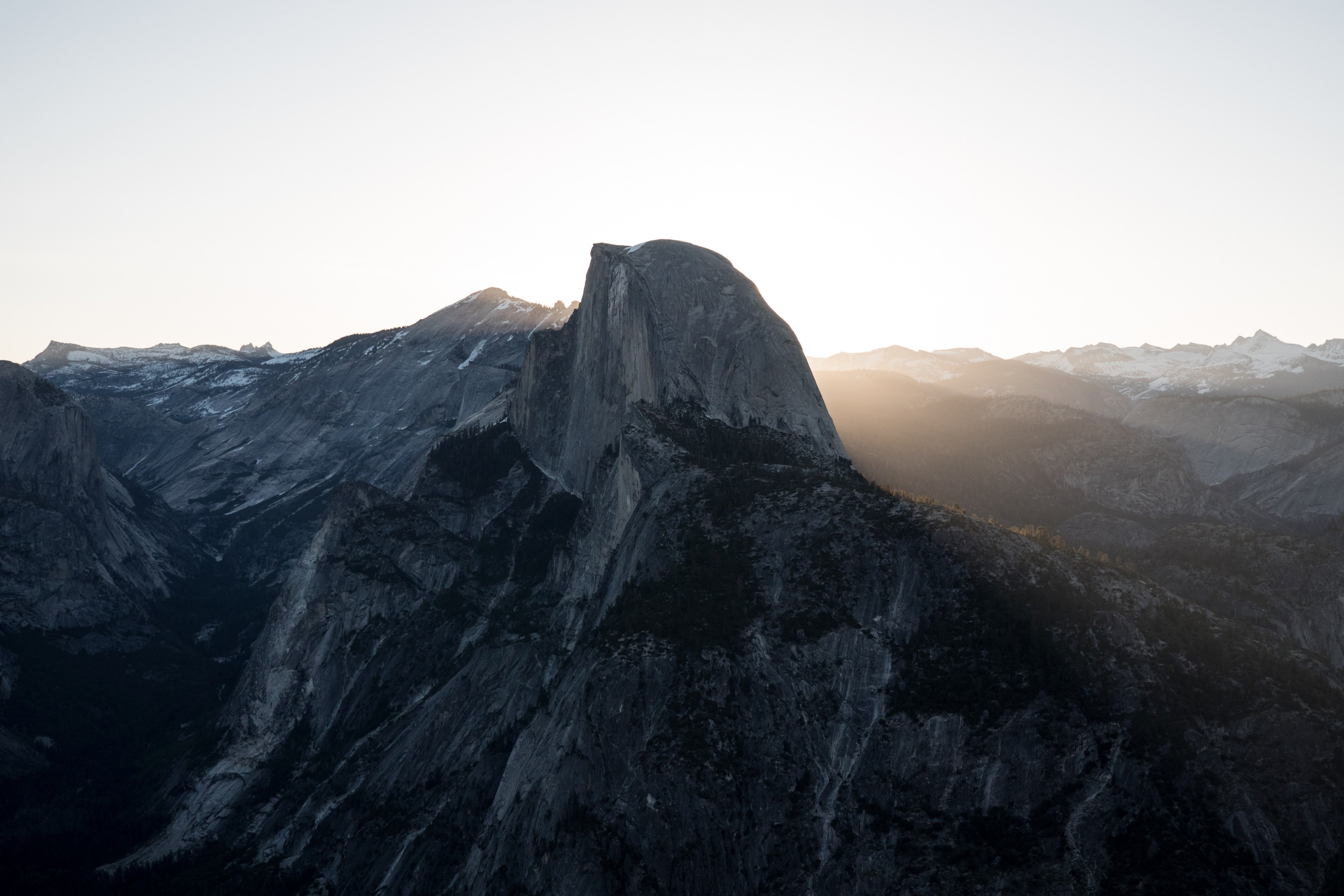 a rocky peak in a mountain range illuminated by the rays of the sunset, glowing rocky mountain peak 4k, HD Wallpaper
