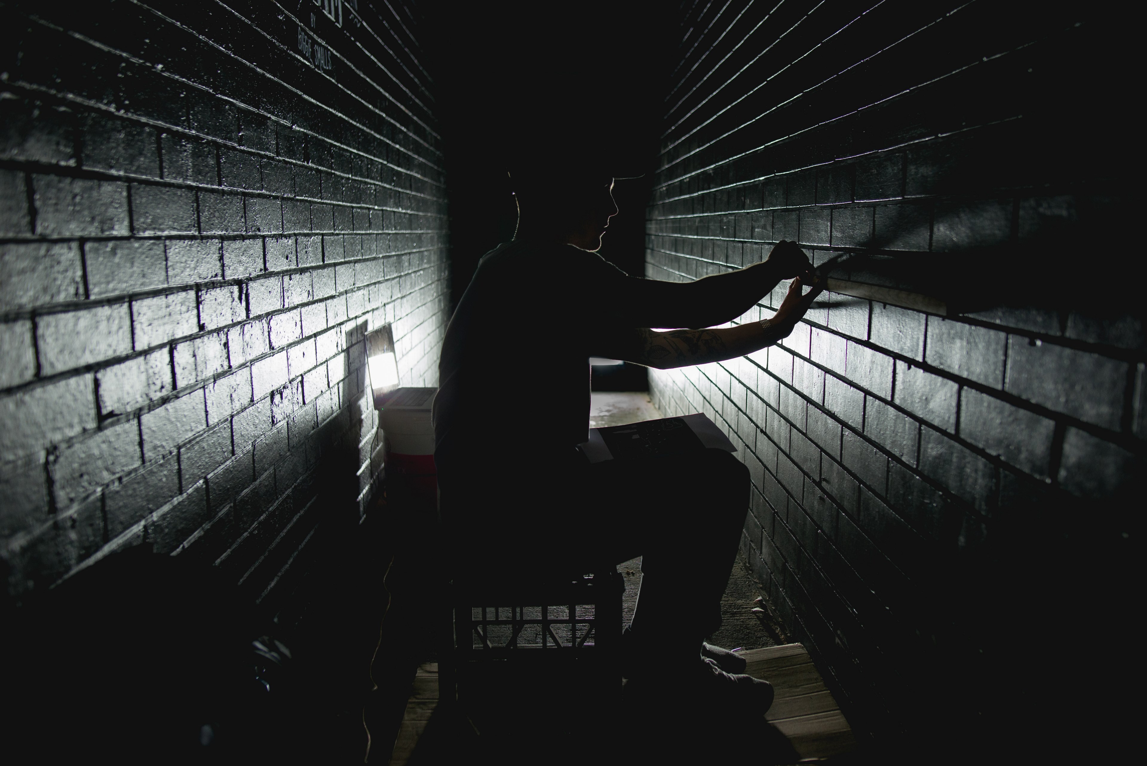 a man works in a dark corridor measuring bricks in adelaide, man in dark hallway 4k, HD Wallpaper