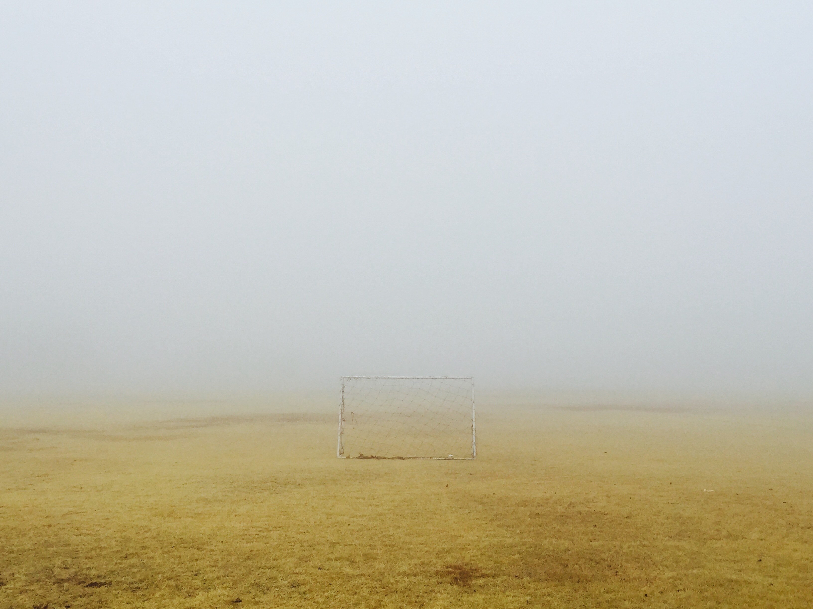 small soccer goal sitting on the yellow scorched grass field on a foggy day, small soccer goal on a foggy field 4k, HD Wallpaper