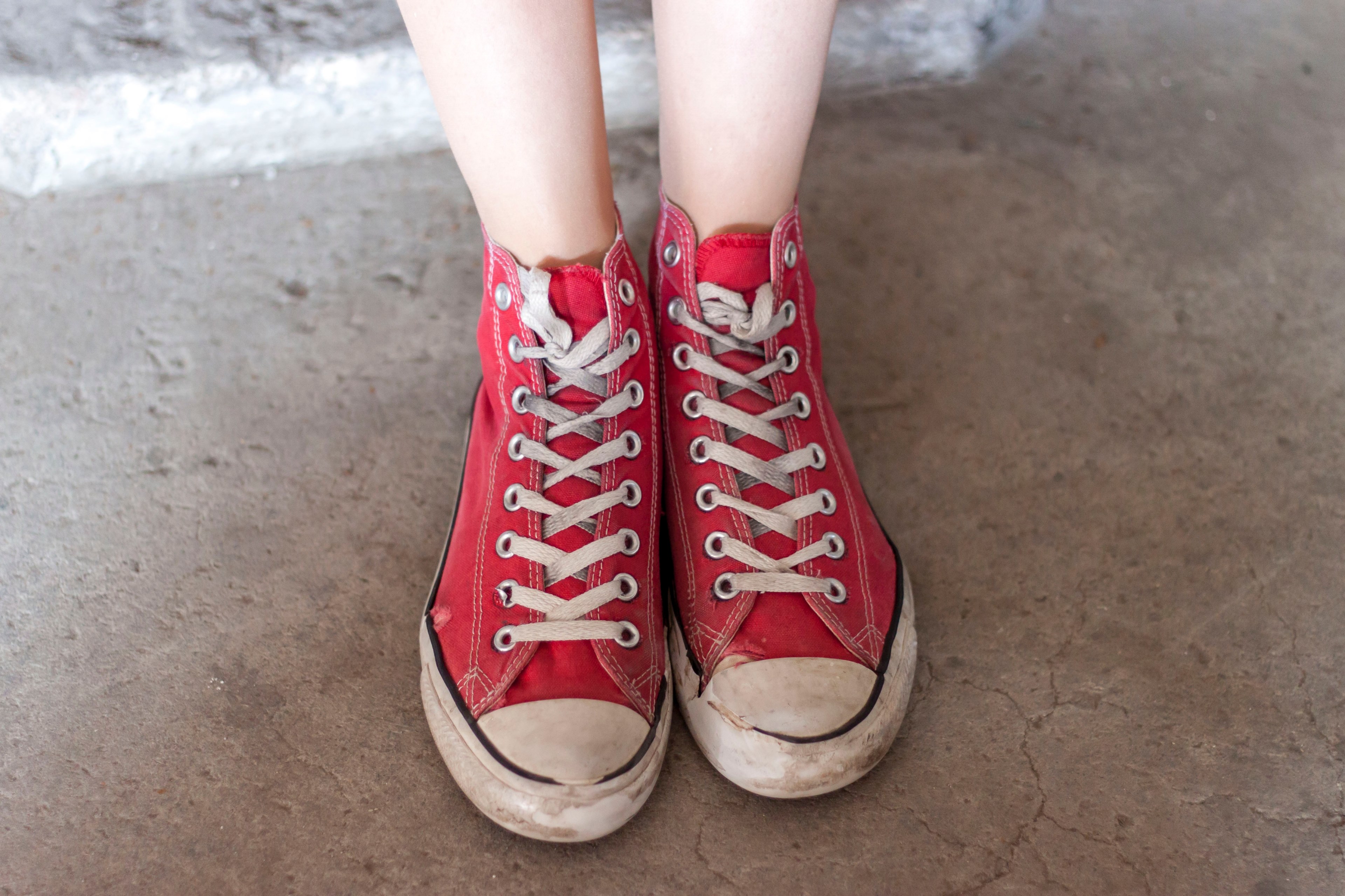 a macro shot of a person wearing laced converse shoes on cement, laced converse shoes 4k, HD Wallpaper