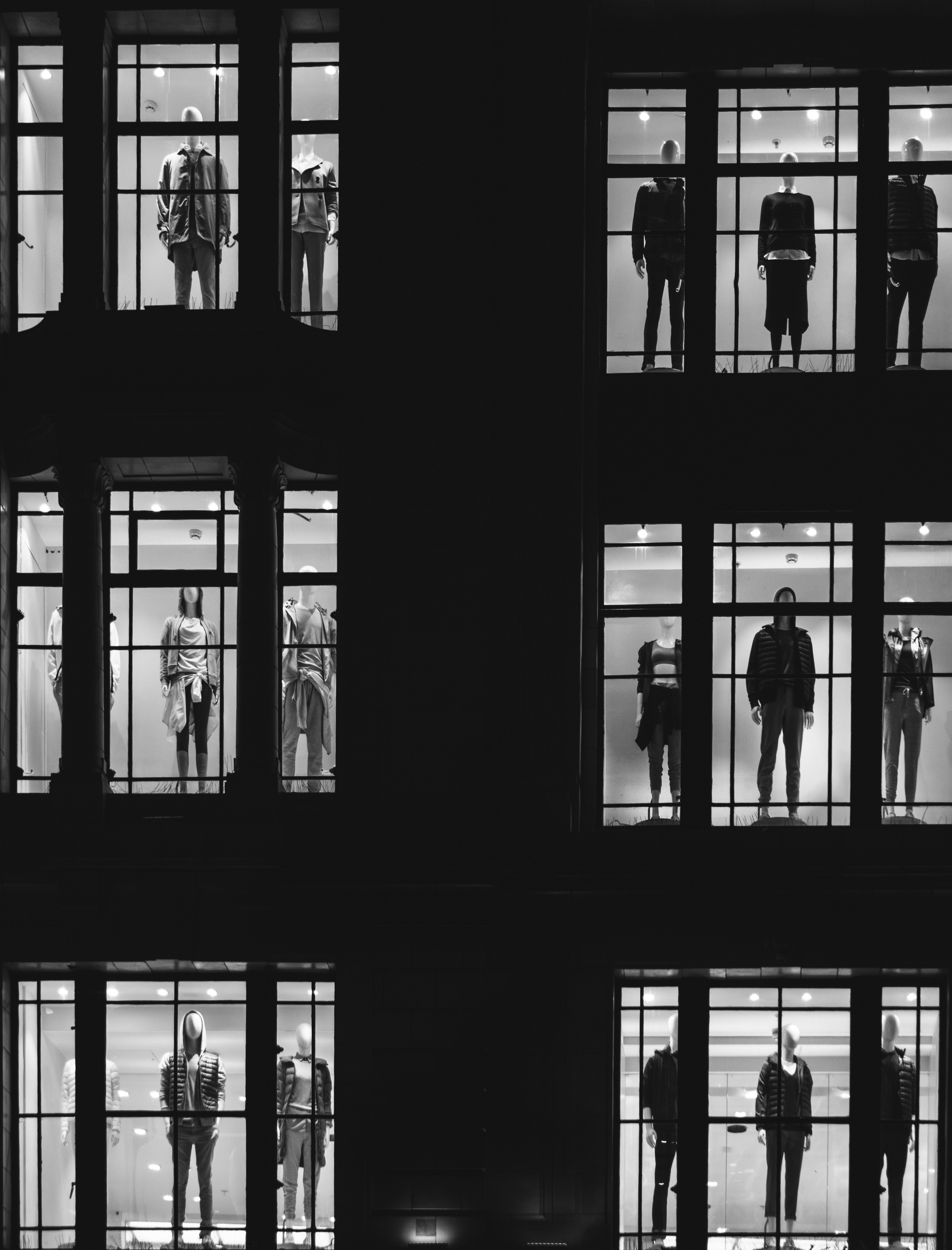 black and white shot of urban building windows at night with people standing inside oxford street, manequin display 4k, Phone HD Wallpaper