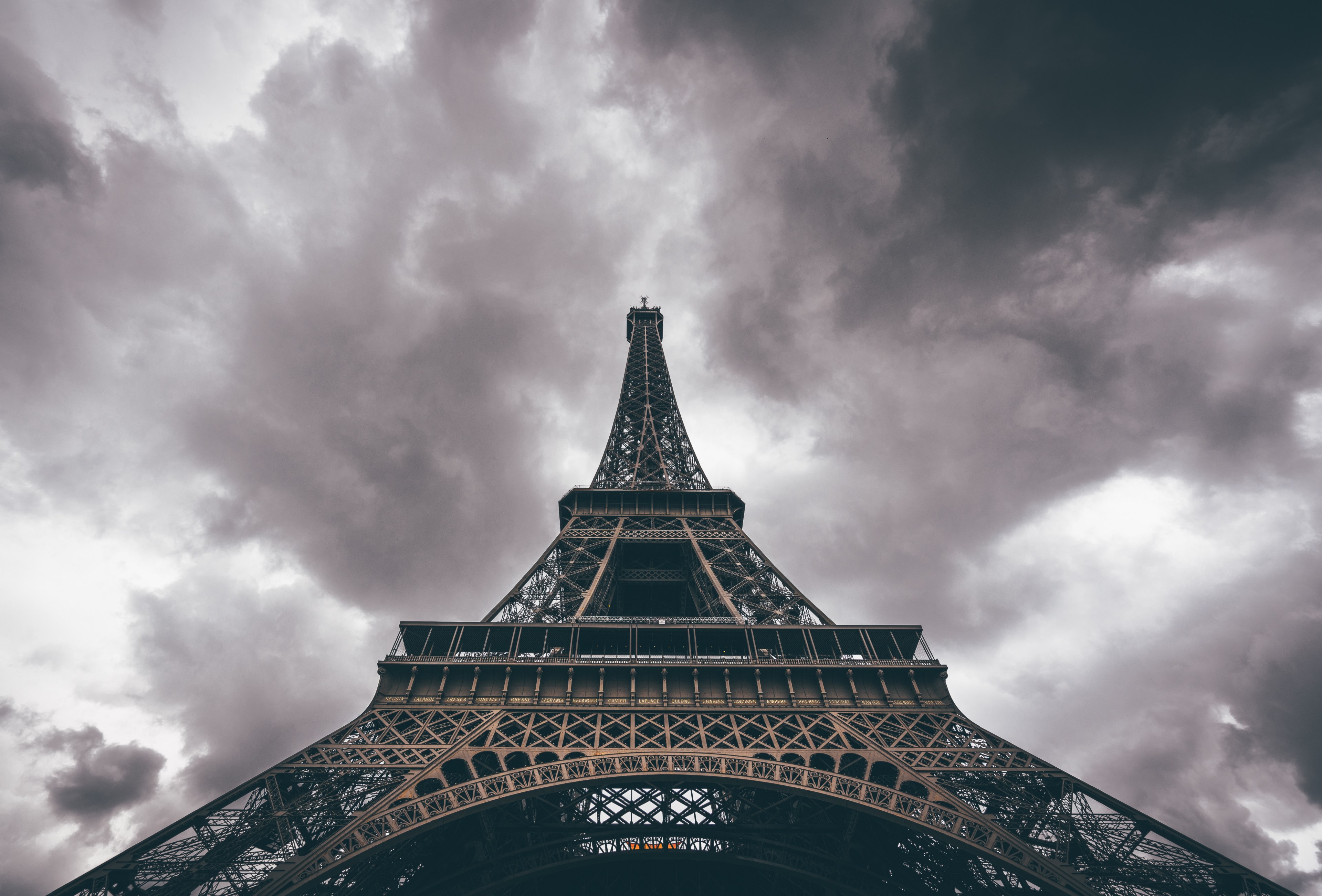 a greyscale shot looking up at the eiffel tower in paris with storm clouds behind it, eiffel tower on a stormy day 4k, HD Wallpaper