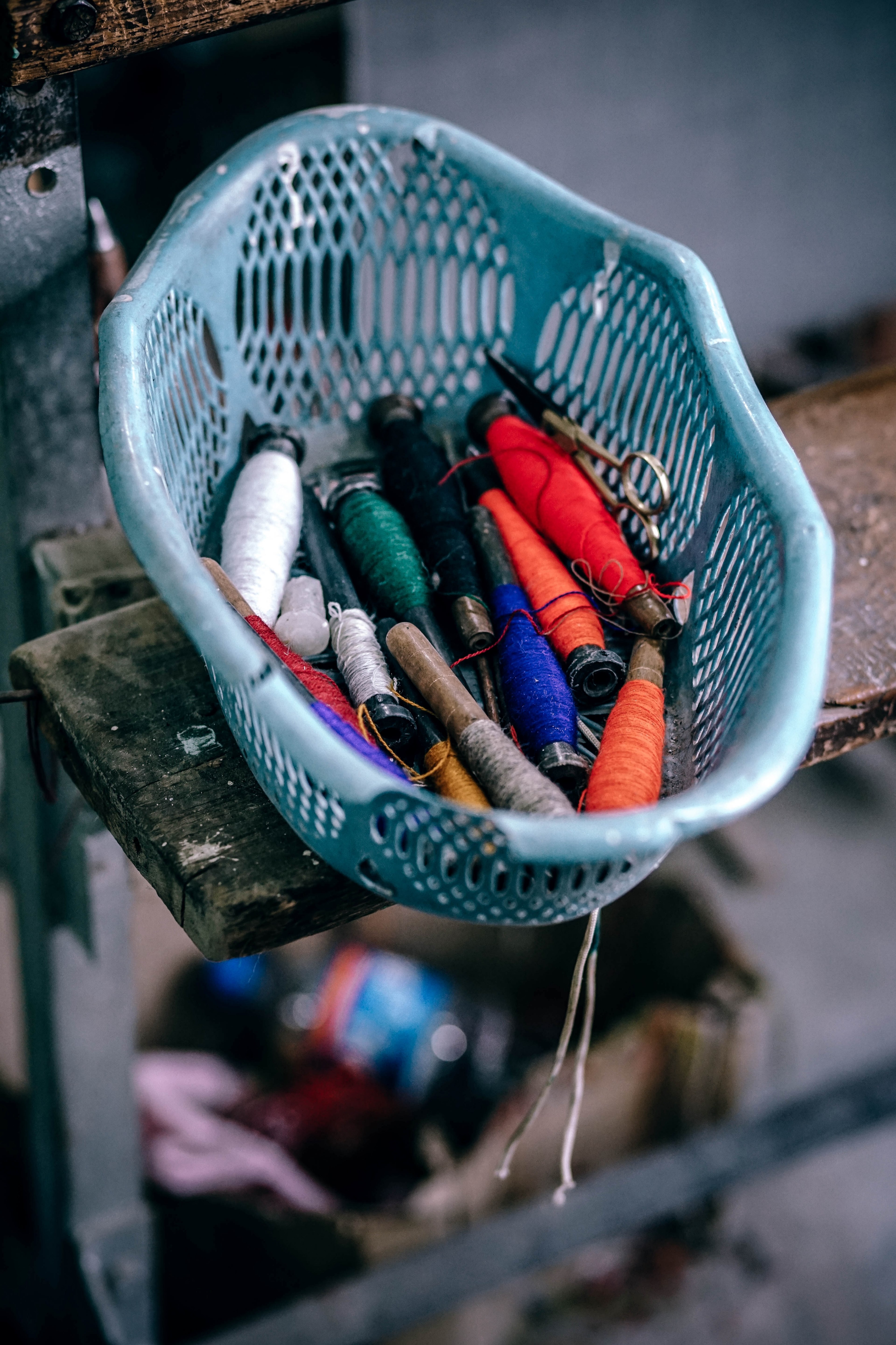a blue basket filled with orange green white and brown thread on a shelf at manu temple road, sewing supplies 4k, Phone HD Wallpaper