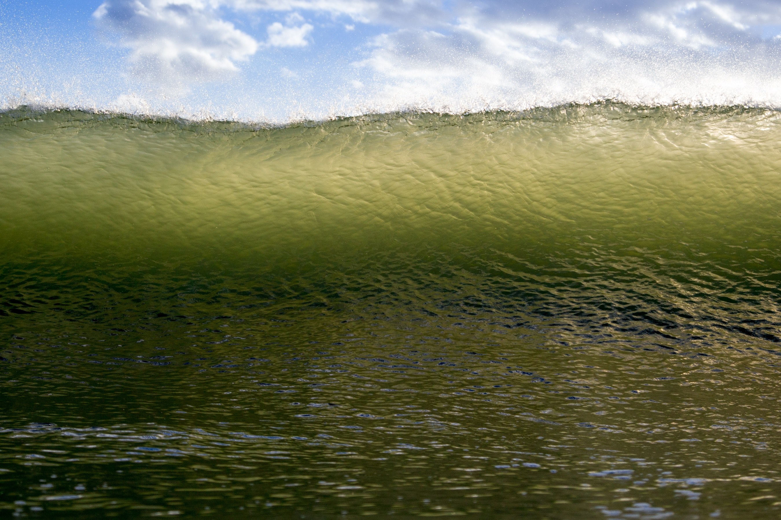 a perspective shot of a large wave about to roll over the sea beneath a blue cloudy sky, green wave under a blue sky 4k, HD Wallpaper