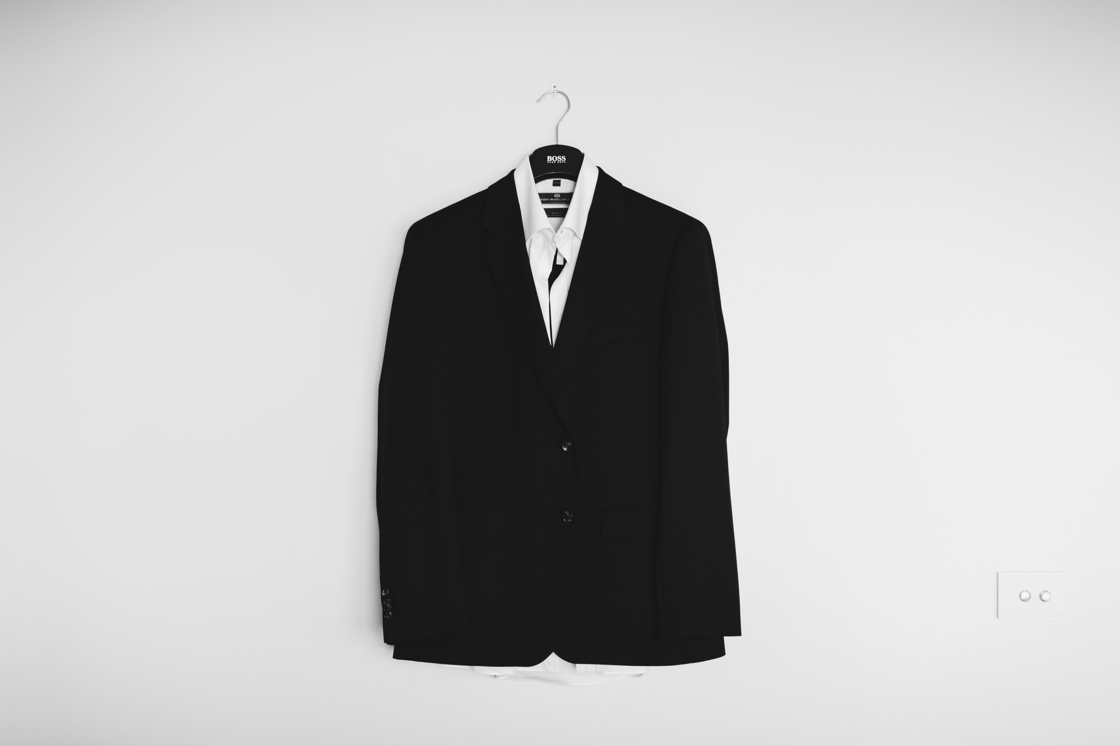 a black suit jacket on a hanger on a white wall, floating groom ghost 4k, HD Wallpaper