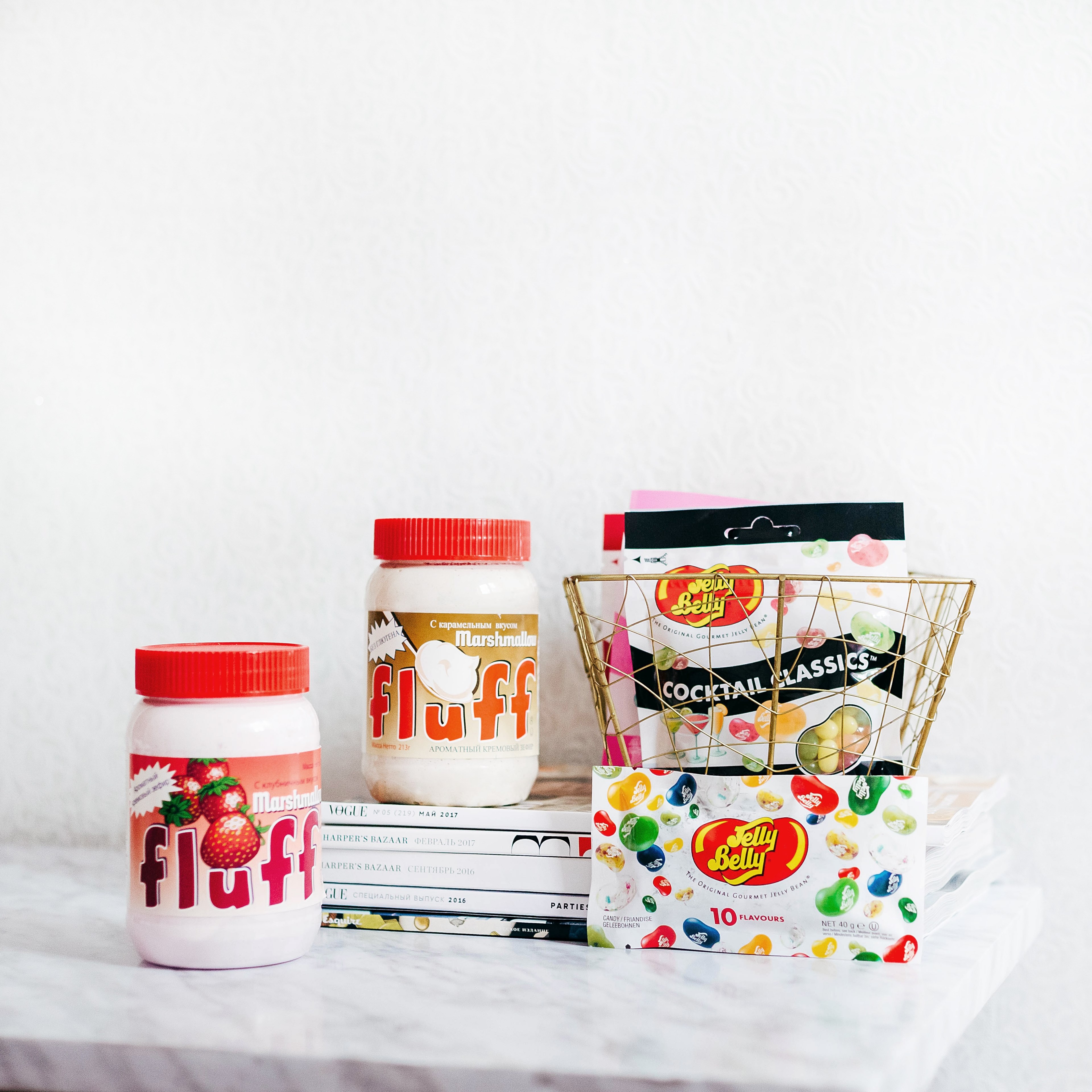 two jars of marshmallow fluff and packages of jelly belly candies on a white marble counter, candy 4k, HD Wallpaper