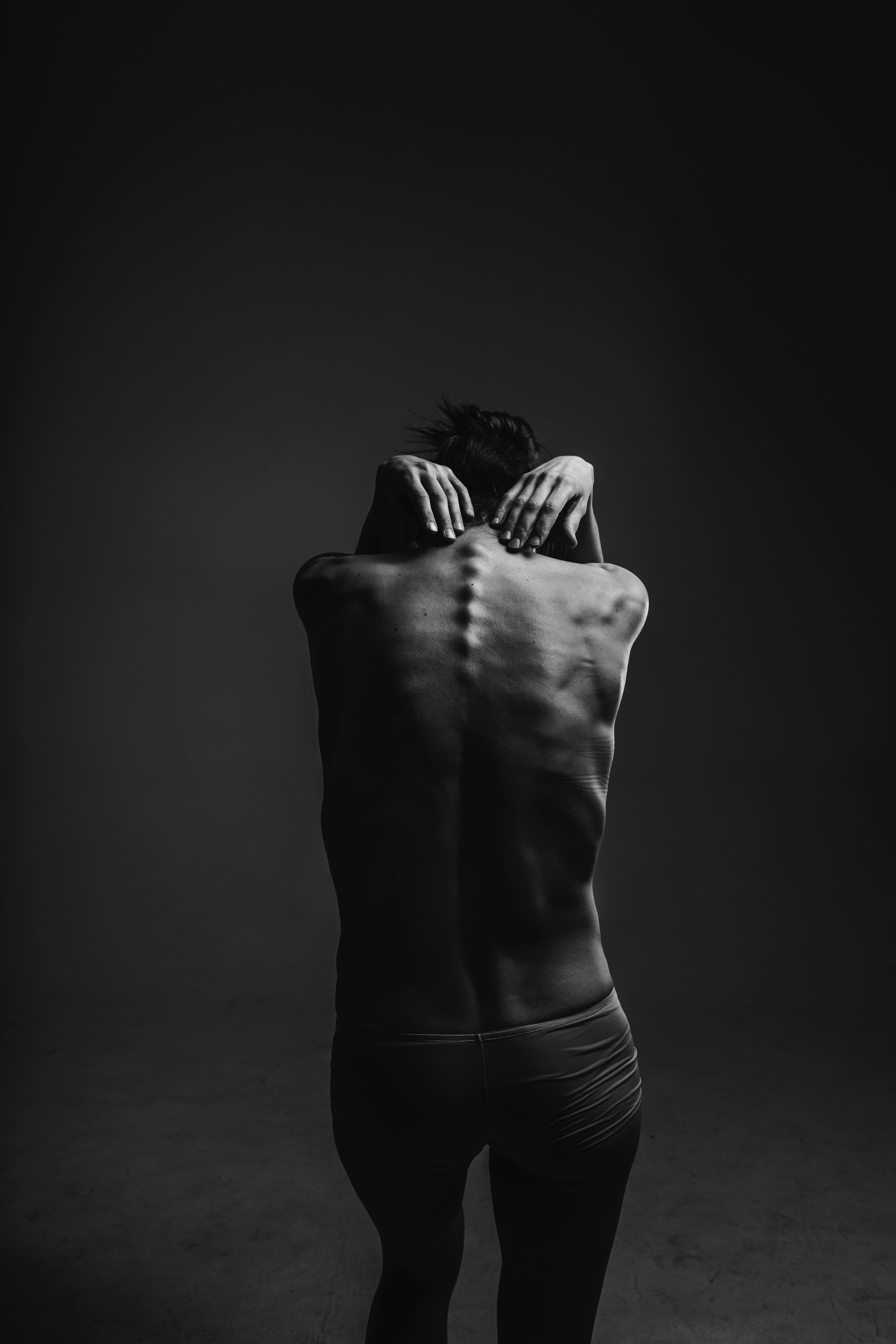 a black and white image of a person sticking their spine out in a photography studio in kyiv city, kyiv city fine art 4k, Phone HD Wallpaper