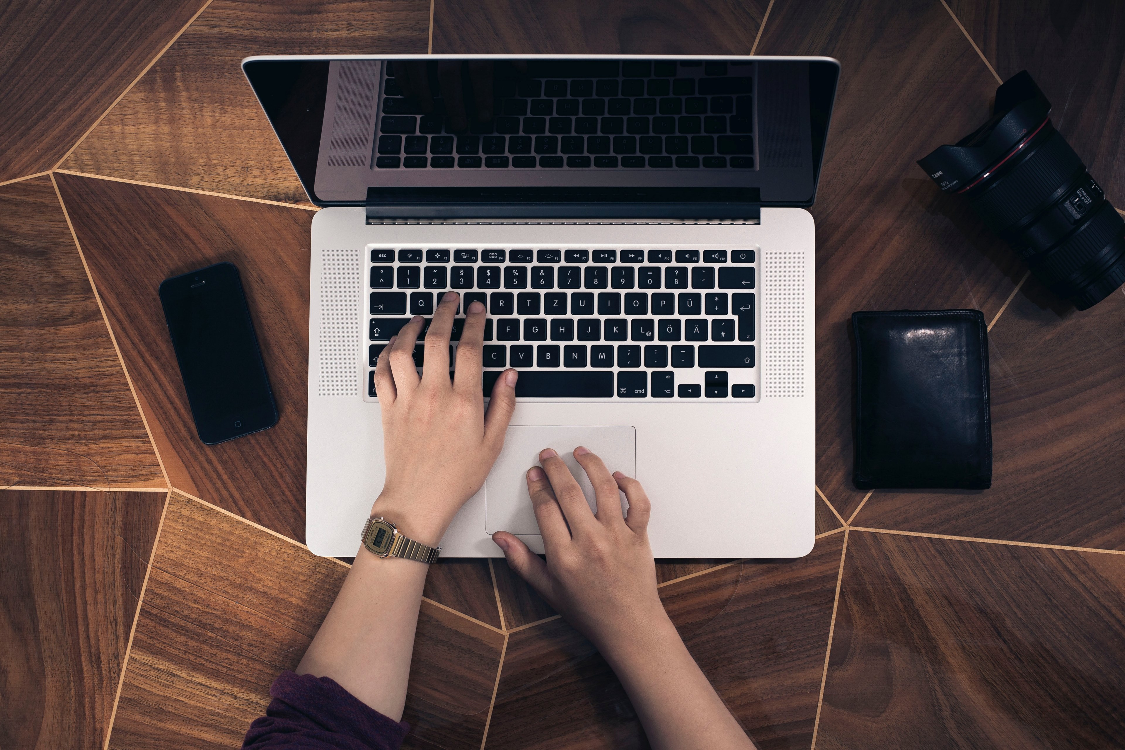 a persons hands on a laptop keyboard with a smartphone and a wallet nearby, hands on a laptop keyboard 4k, HD Wallpaper