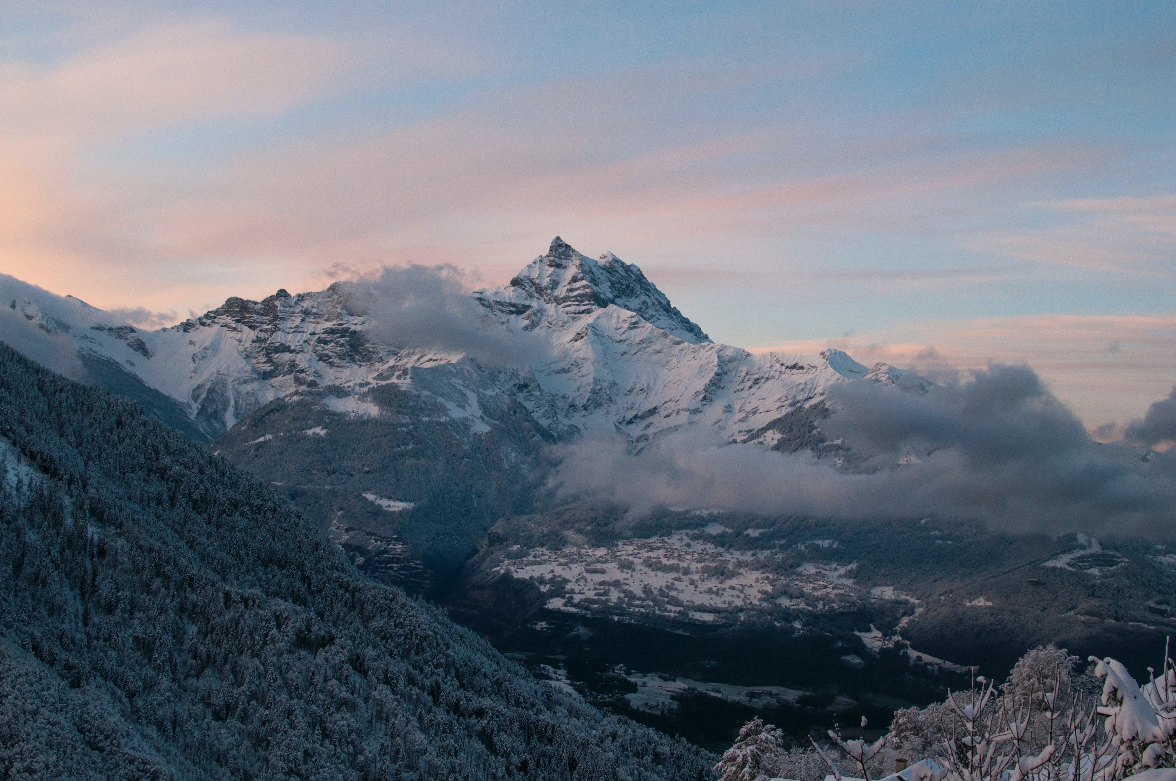 tall snow covered mountains towering over a wooded valley, forest valley in the snowy mountains 4k, HD Wallpaper