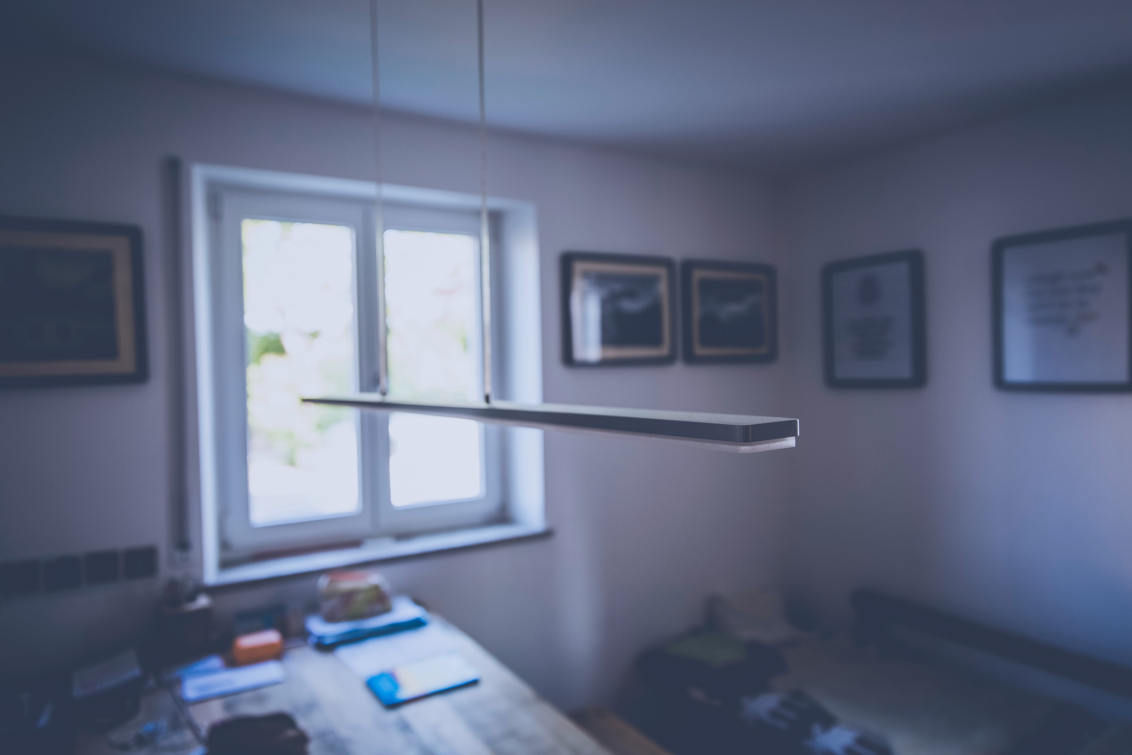 ceiling lamp hangs down in an empty room with a table, table in workroom 4k, HD Wallpaper