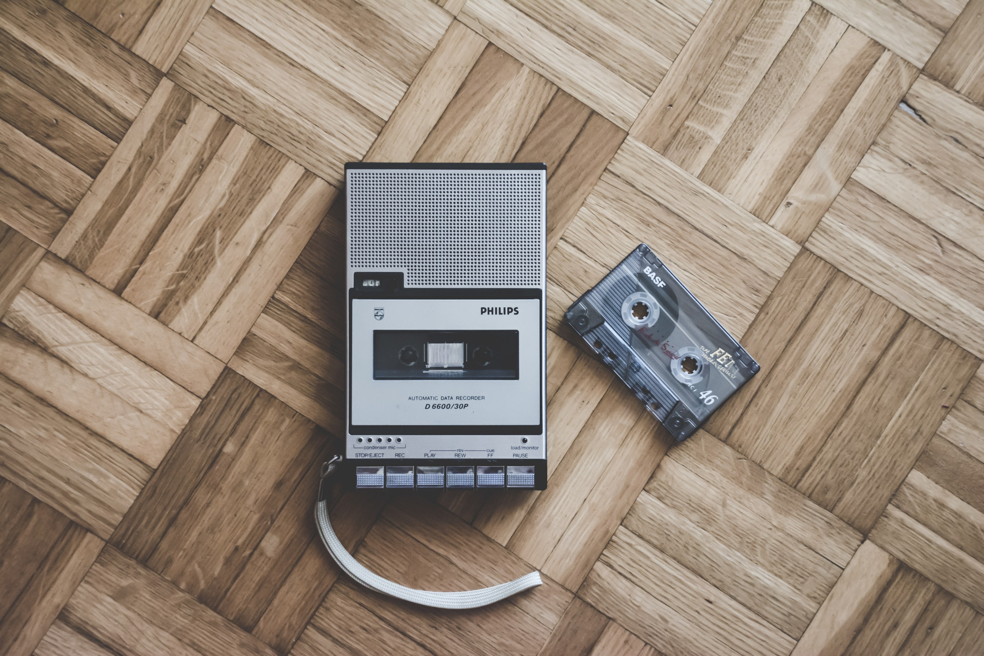 an old philips cassette player and tape laying on a wooden floor in italy, old but gold 4k, HD Wallpaper