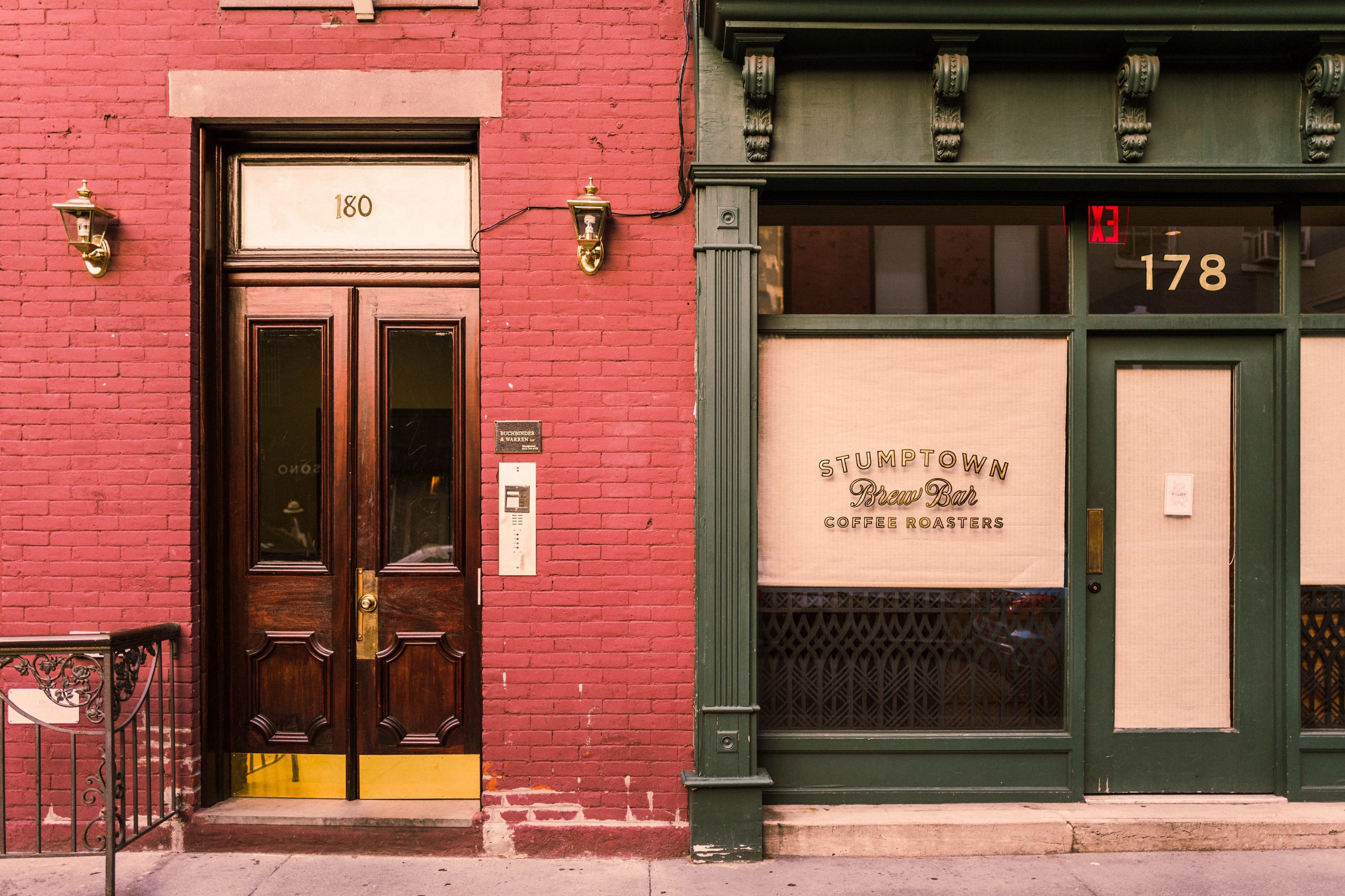 a green painted storefront at the entrance to a coffee shop next to a red wall in new york, green new york coffee shop entrance 4k, HD Wallpaper