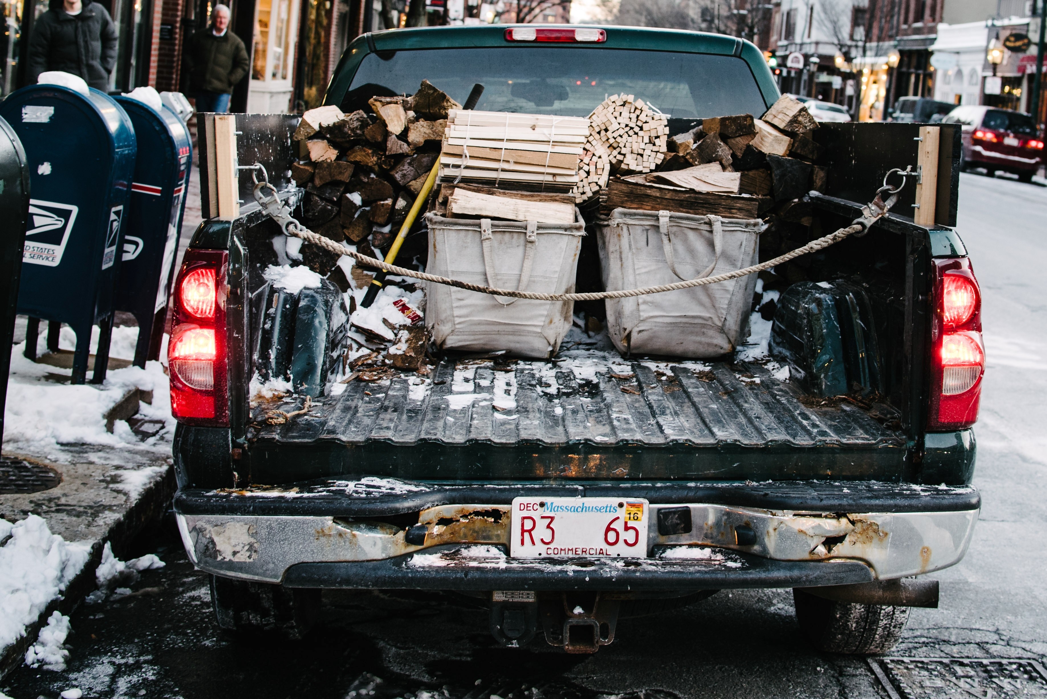 open flatbed of a truck in boston winter containing chopped wood and storage baskets, back of a truck in boston 4k, HD Wallpaper