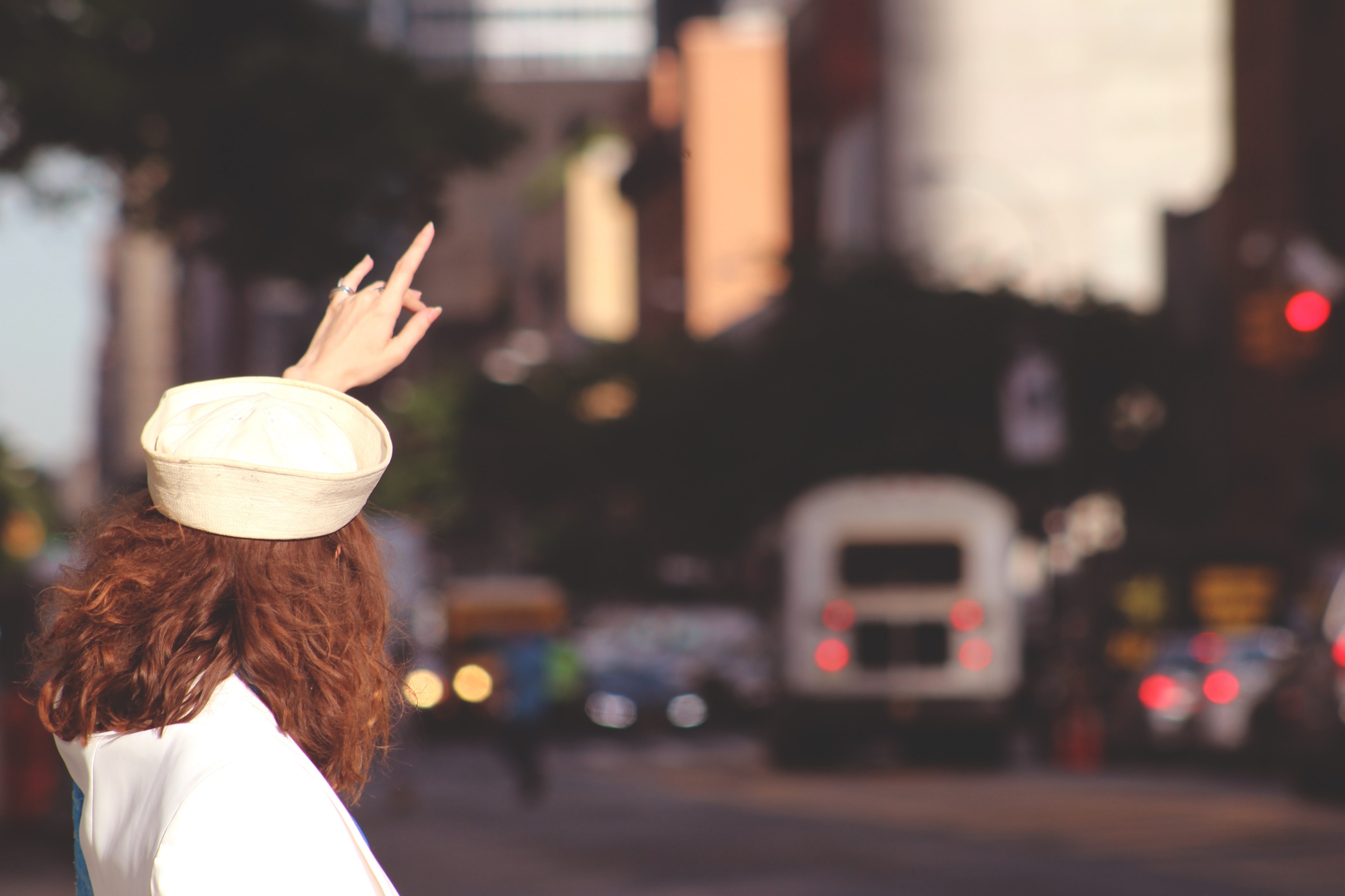 a brown haired woman in a white hat hailing a taxi, tourist catching a taxi 4k, HD Wallpaper