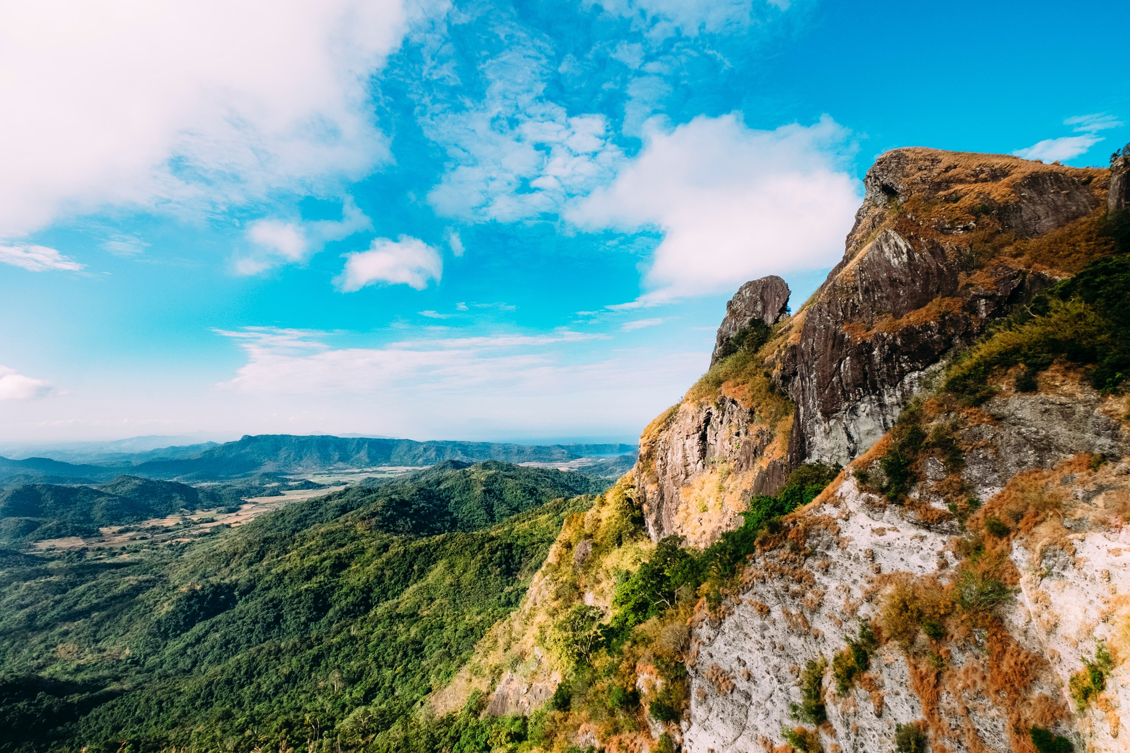 a rock formation covered in brown moss near green hills, brown moss on rocks 4k, HD Wallpaper
