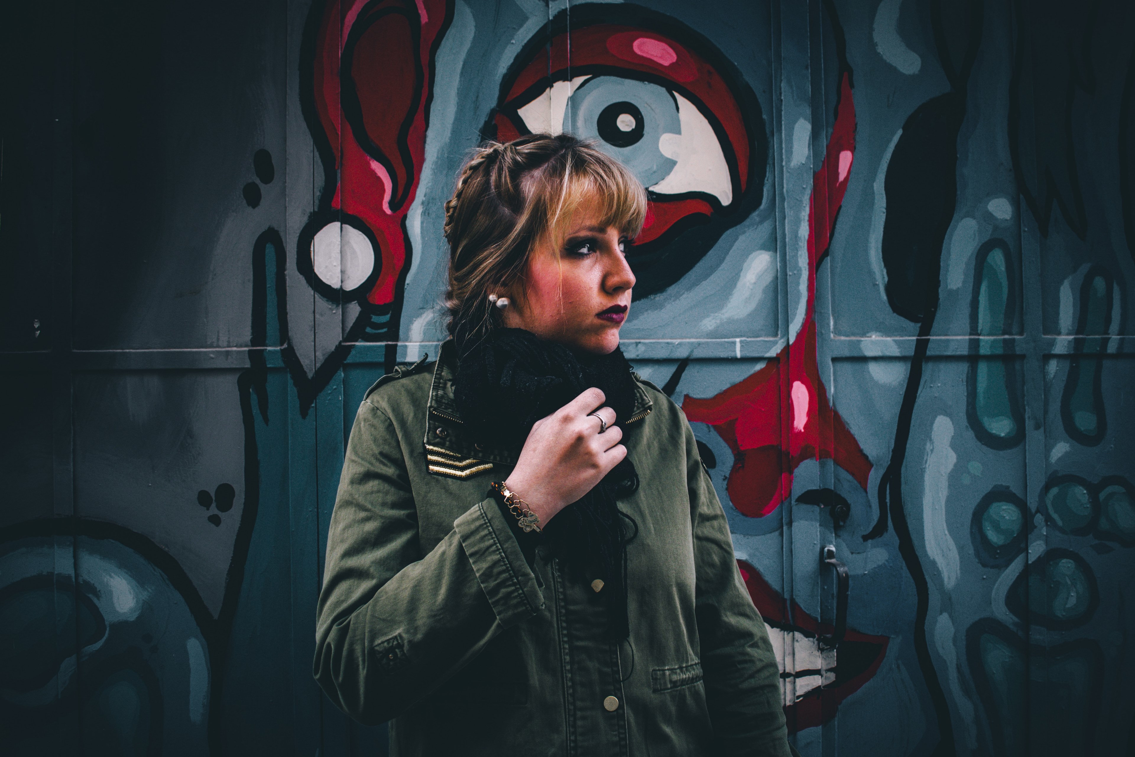 young attractive blonde woman in front of haunting graffiti with eye in salamanca, woman in front of dark graffiti 4k, HD Wallpaper