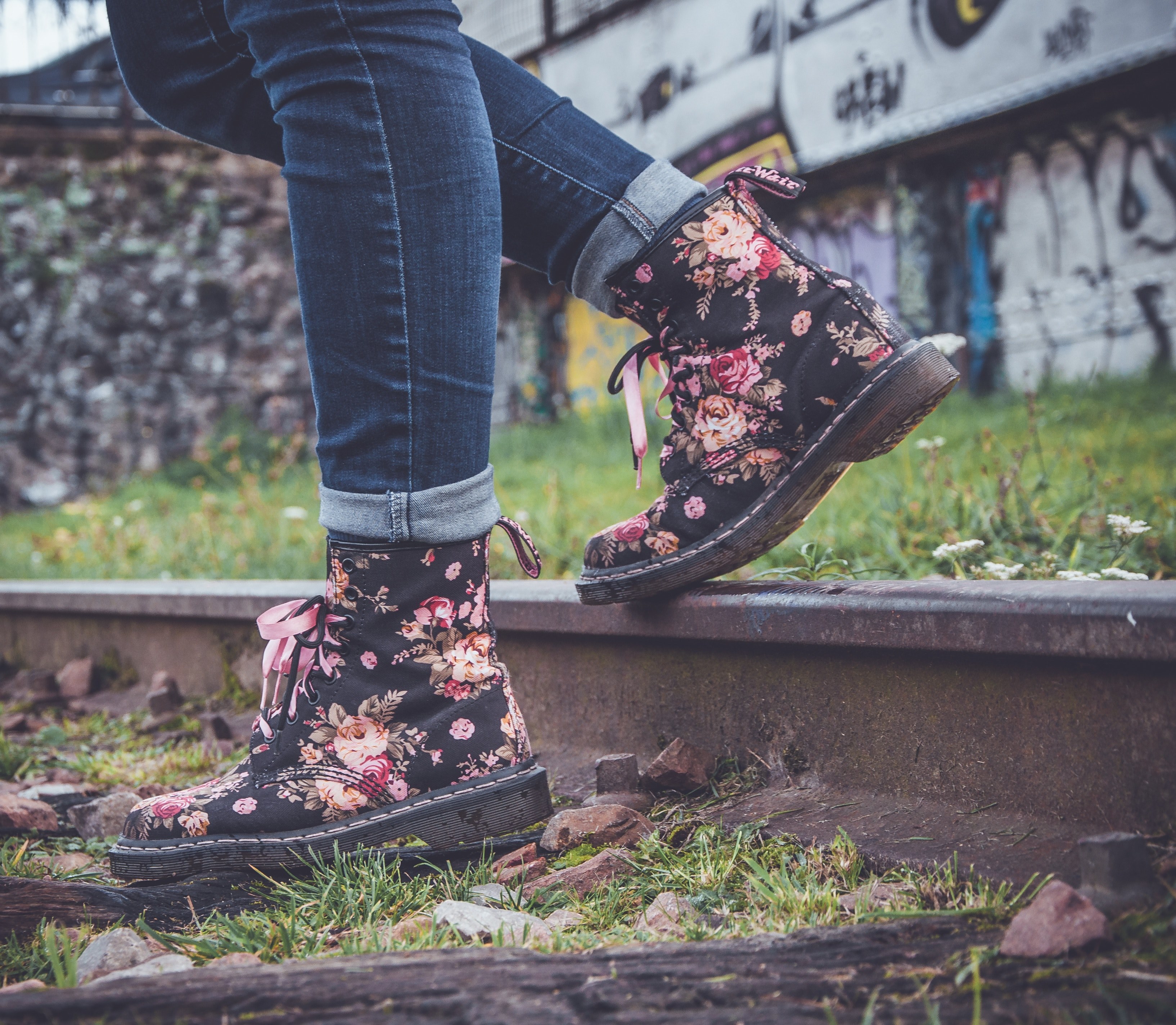 a close up shot of a person wearing floral boots stepping on a railway track with graffiti behind, floral boots and graffiti 4k, HD Wallpaper
