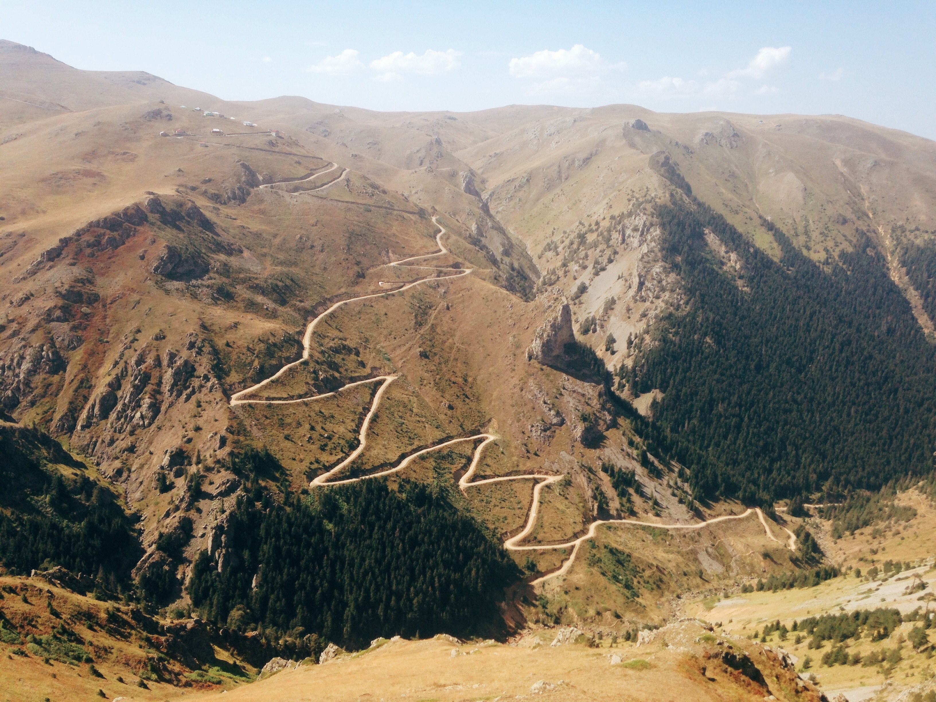 a zigzagging dirt road up a semi arid mountain slope, dirt road up the dry mountain 4k, HD Wallpaper