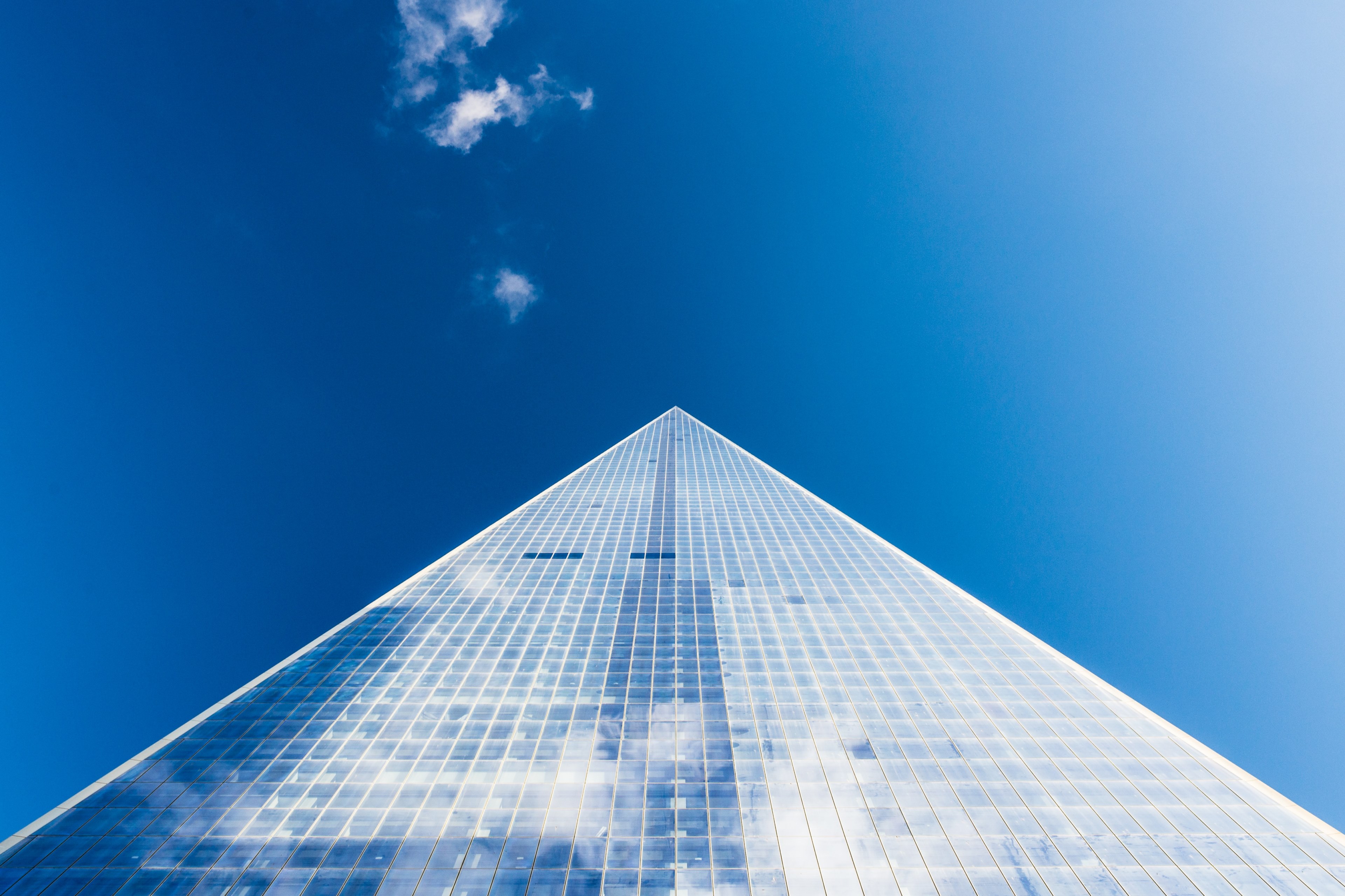 a low angle shot of an imposing skyscraper against a blue sky, nyc pyramid 4k, HD Wallpaper