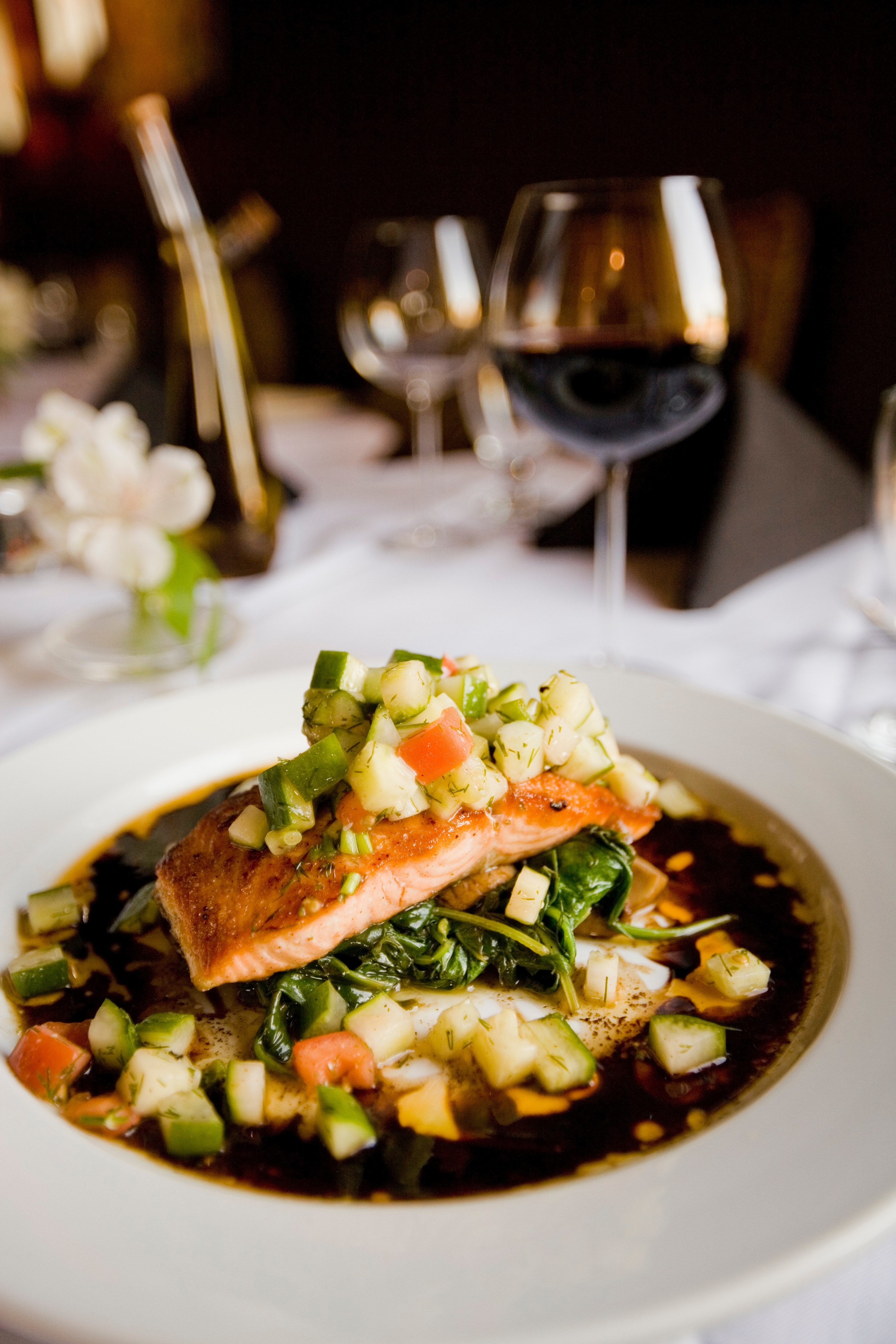 a deep dish with a meal with salmon and zucchini next to a wine glass on a white tablecloth, meal with salmon and zucchini 4k, Phone HD Wallpaper