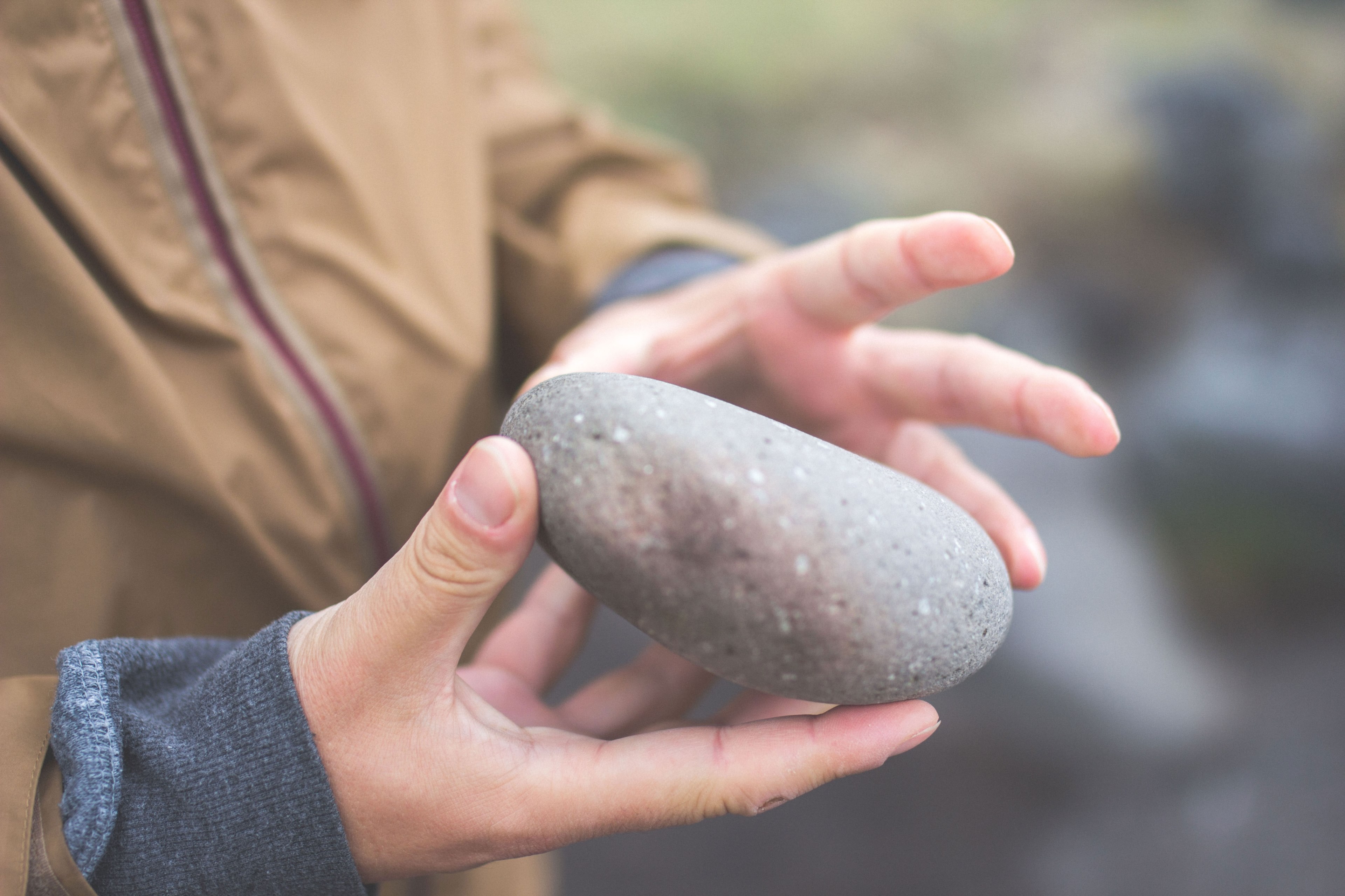 a male holding a smooth stone in his hands, stone in hand 4k, HD Wallpaper