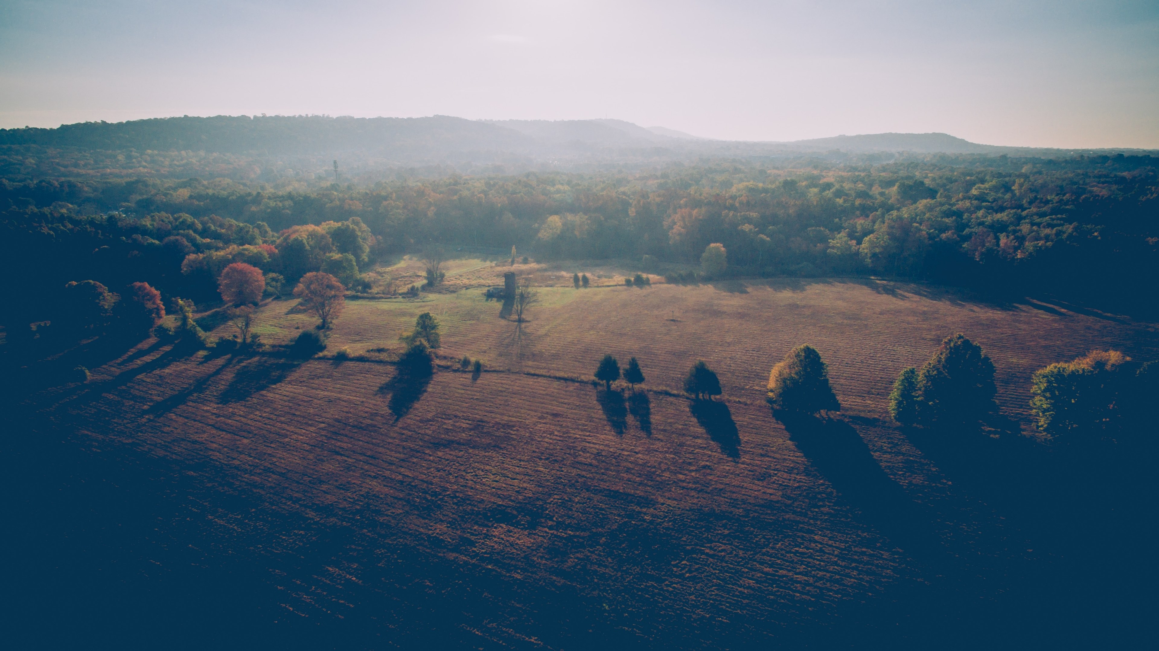 a hazy shot of autumn forests around plowed fields in somerset county, plowed fields and autumn trees 4k, HD Wallpaper