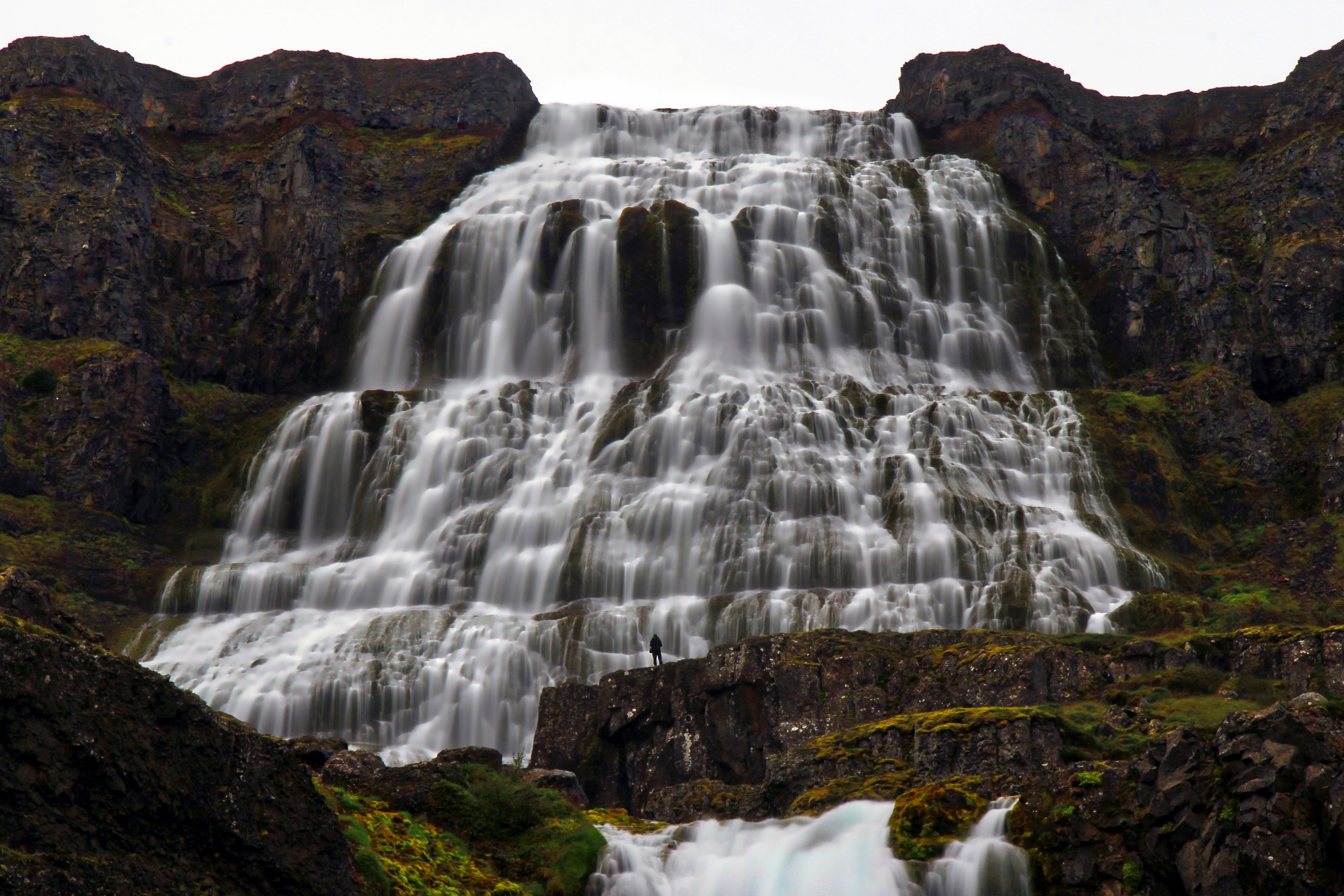 a scenic shot of a waterfall flowing slowly down a rocky mountain, waterfall down a rock mountain 4k, HD Wallpaper