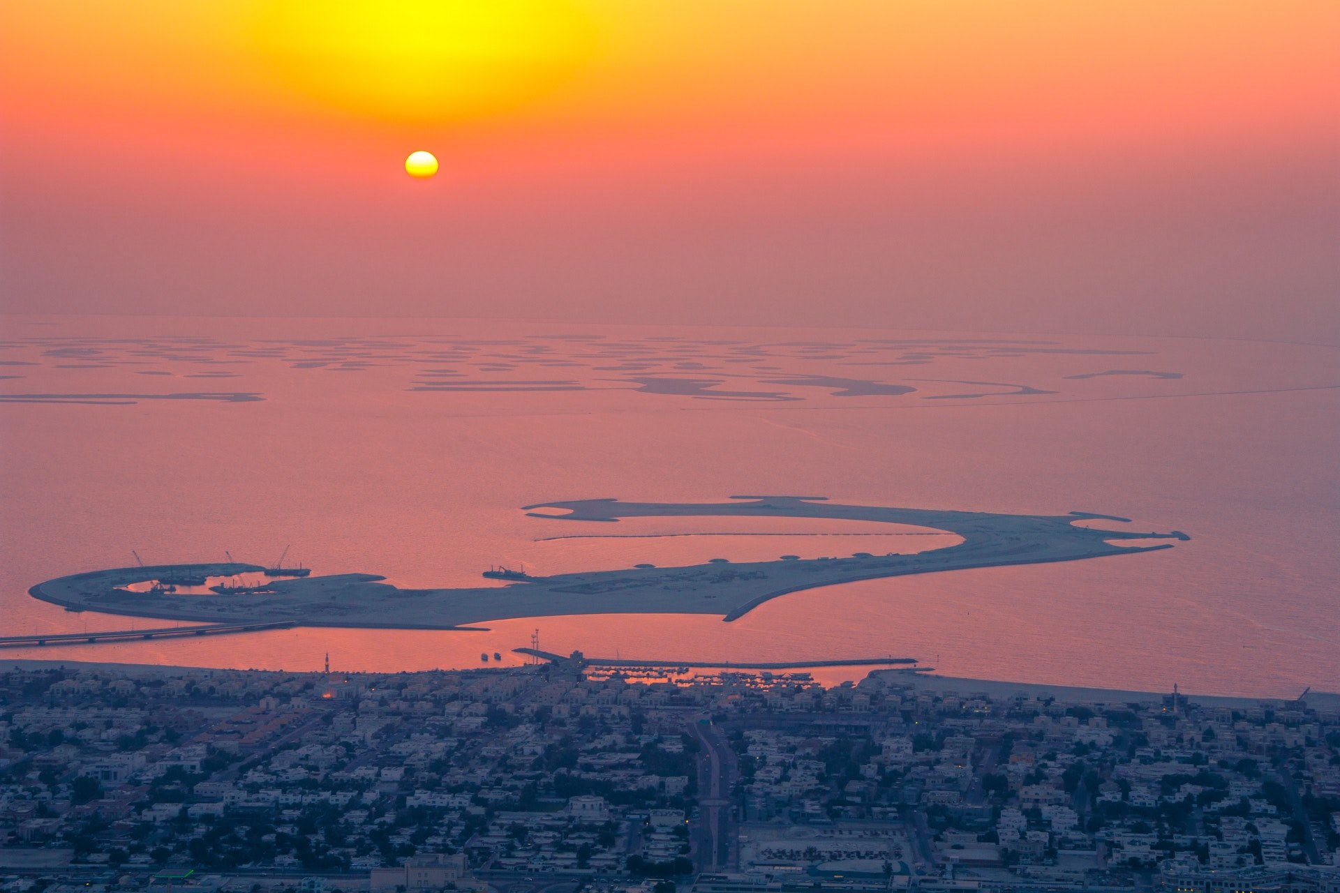 an abstract shaped artificial island on a body of water during sunrise, artificial island at dusk 4k, HD Wallpaper