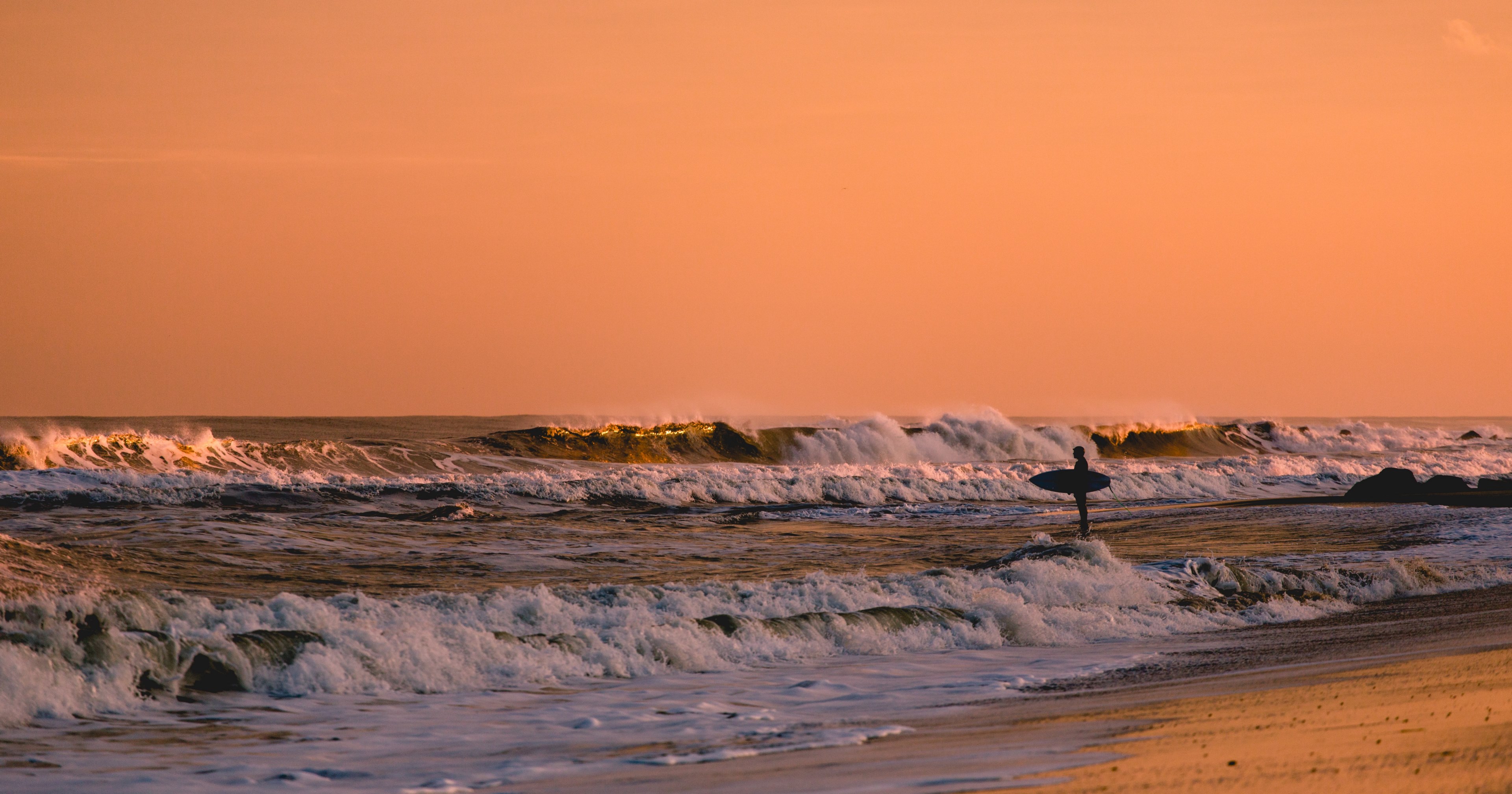 surfer standing in shallow water looking at waves at sunset in bradley beach, the last ride 4k, HD Wallpaper