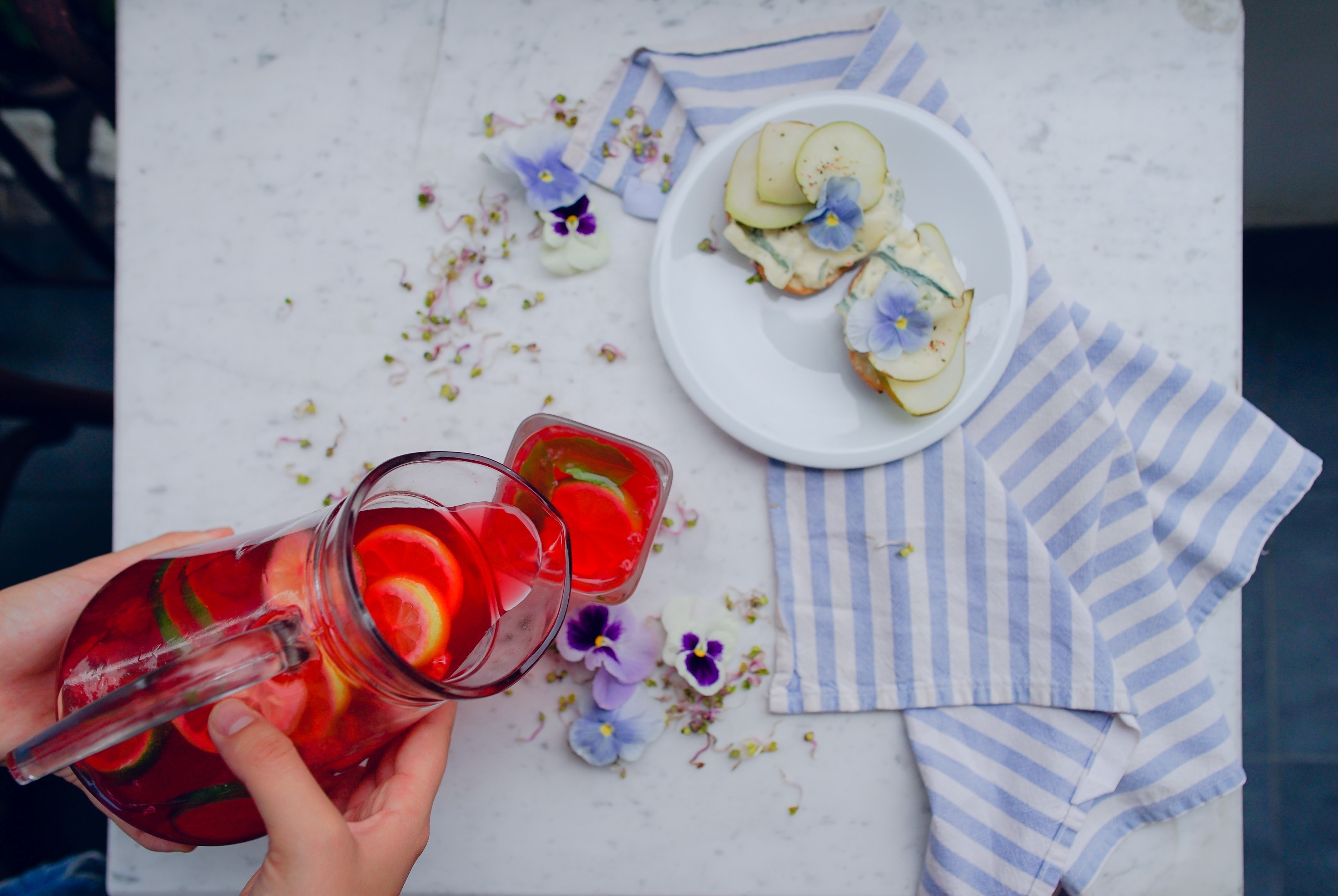 top view of someone pouring juice into a glass next to a plate of snacks, _summer picnic 4k, HD Wallpaper