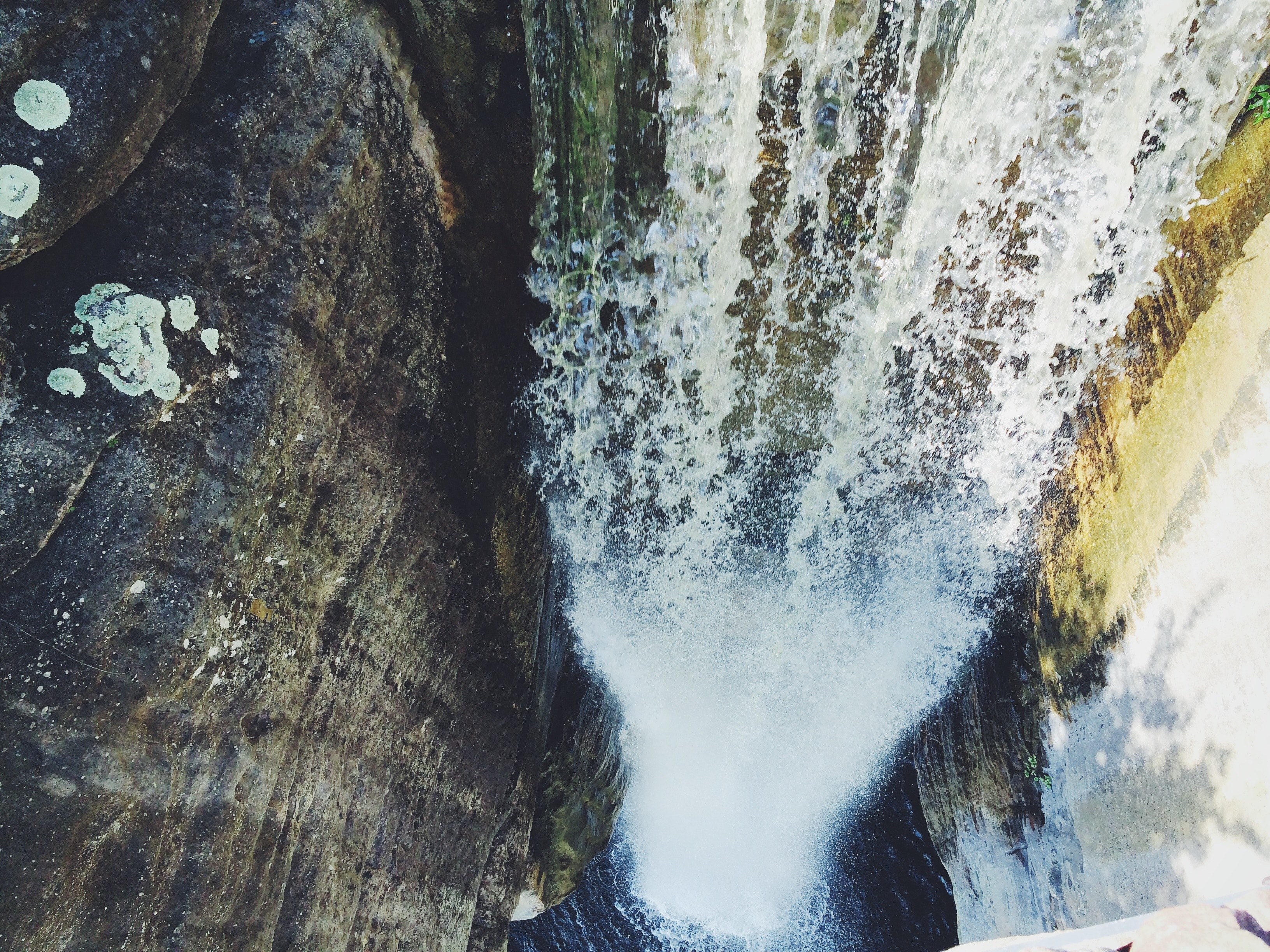 a breathtaking view of a waterfall tumbling down from a steep rock face, looking down the waterfall 4k, HD Wallpaper