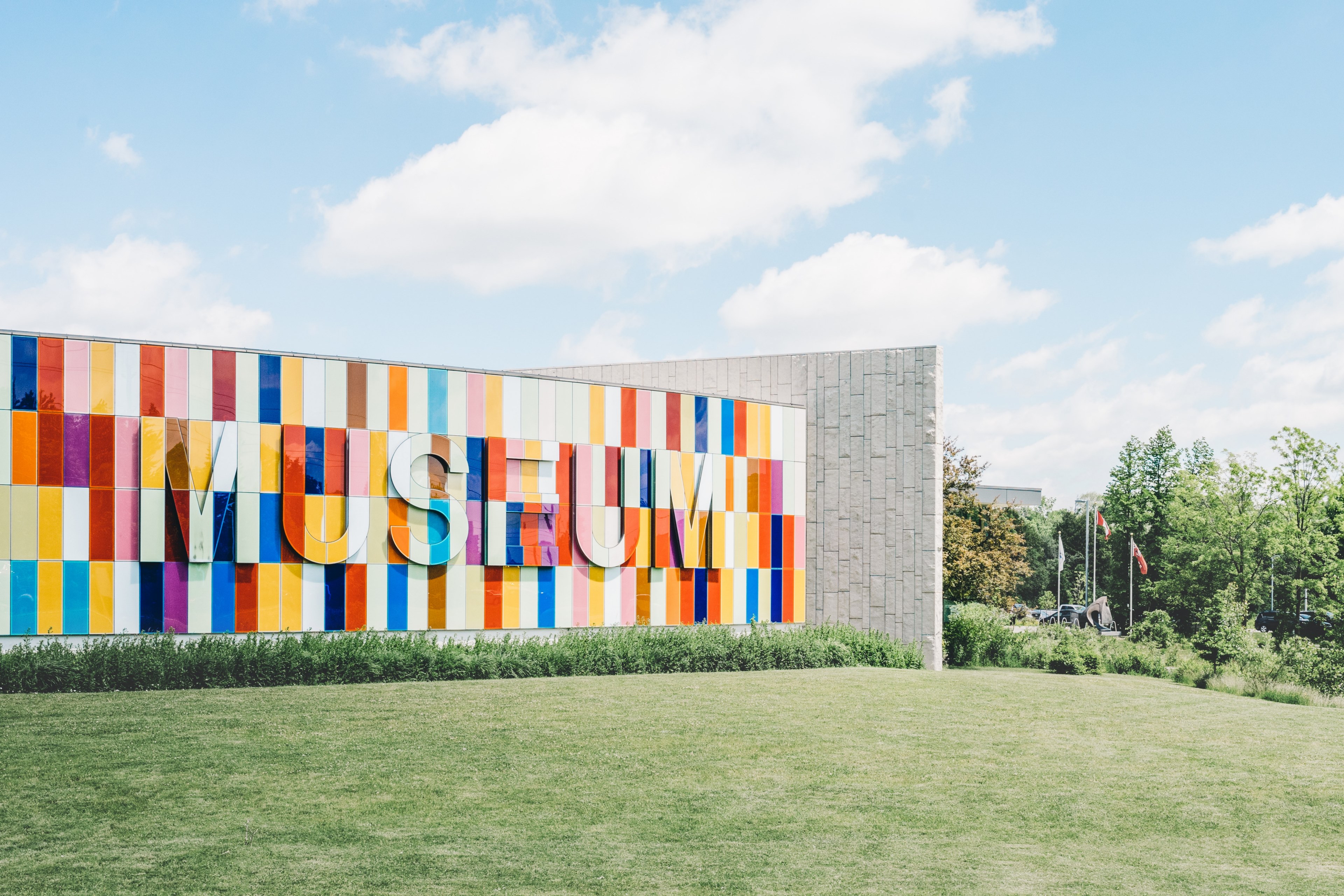 grass and trees with colorful tile museum text sign at waterloo region museum, colorful museum sign on landscape 4k, HD Wallpaper