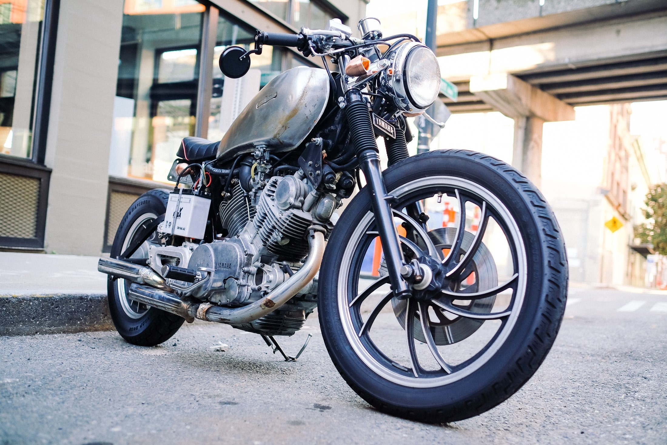 black motorcycle parked on a street near a building, parked motorcycle 4k, HD Wallpaper