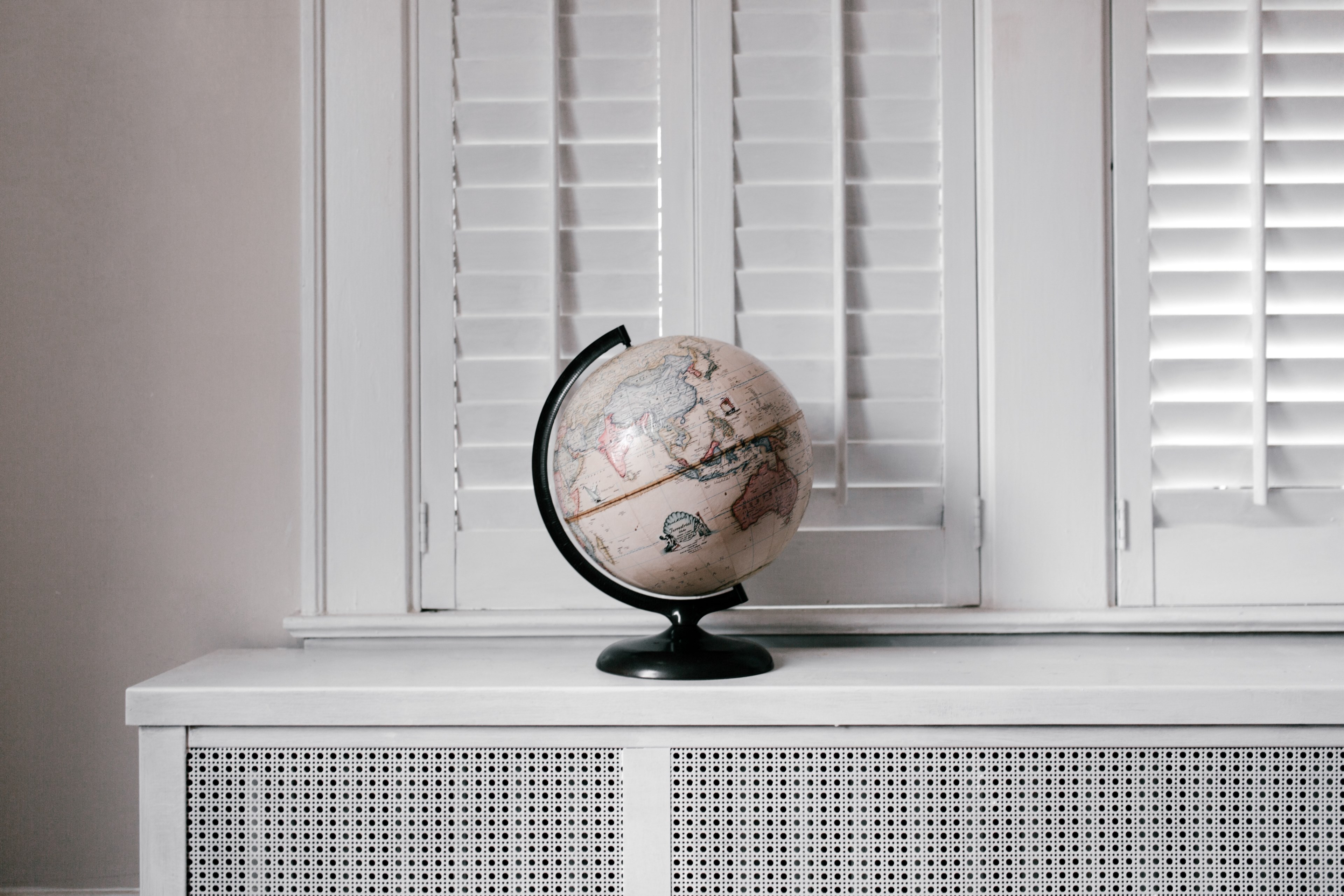 a cream colored globe of the earth sits in a in a completely white room, the remedy is travel 4k, HD Wallpaper